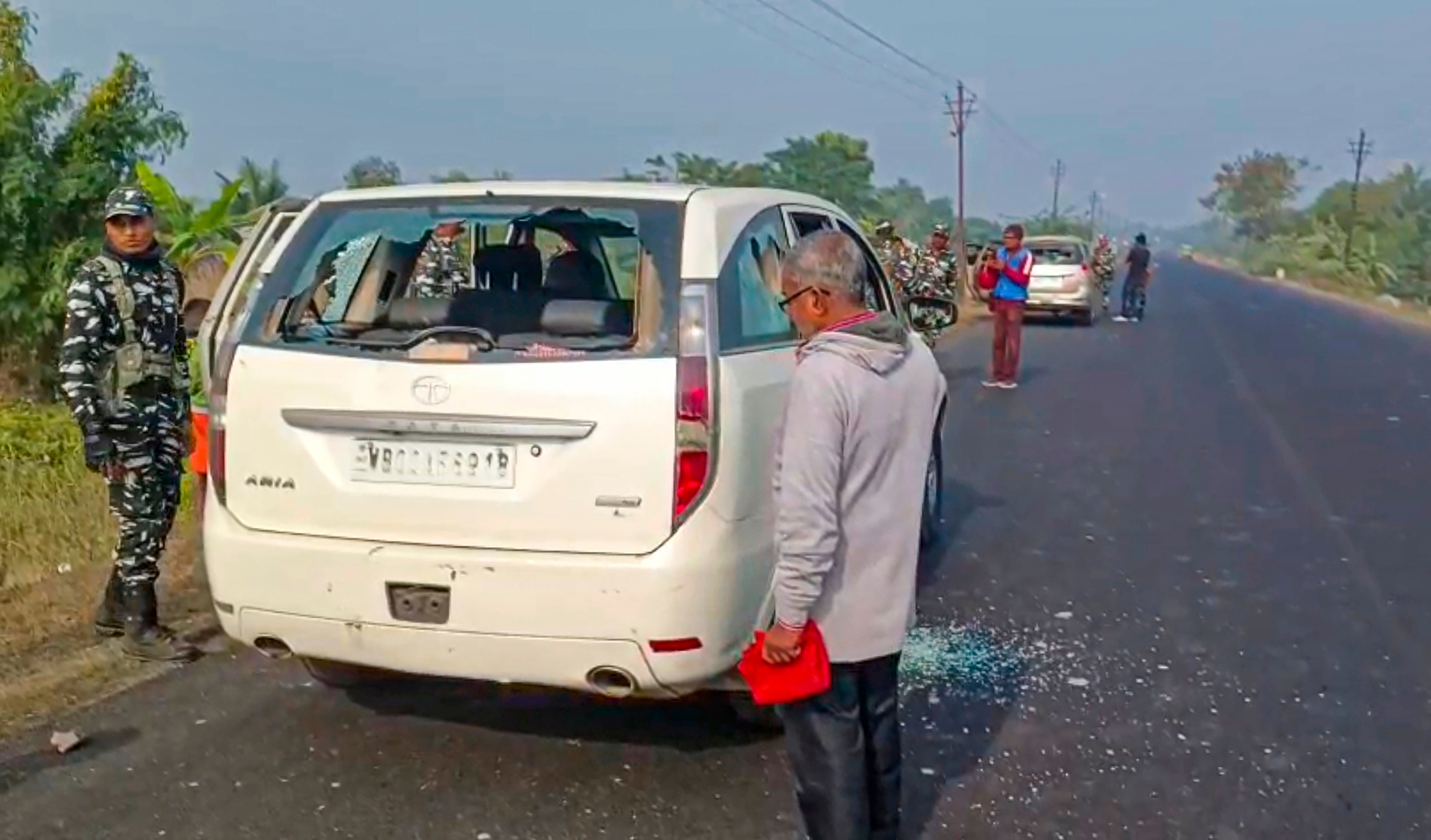 <div class="paragraphs"><p>Security personnel with others stand near a vehicle which was allegedly damaged by the supporters of TMC leader Sheikh Sajahan during a raid by ED officials at his residence, in North 24 Parganas district, Friday, Jan 5, 2024.</p></div>