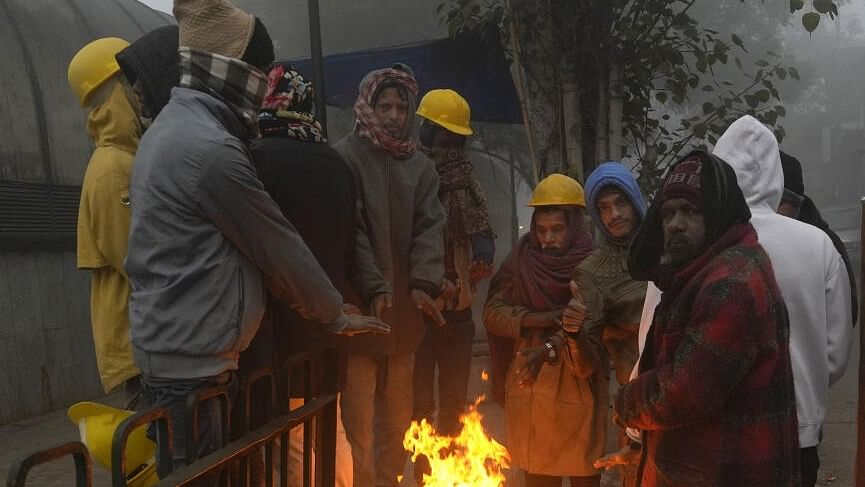 <div class="paragraphs"><p>Representative image of people huddle around a bonfire amid fog on a cold winter morning.</p></div>