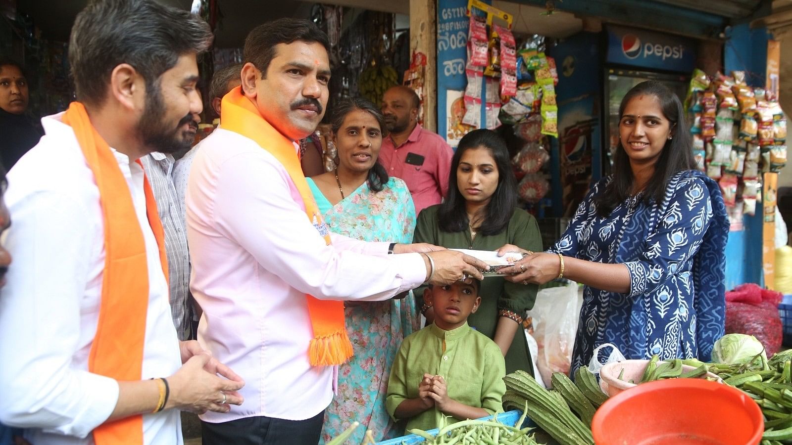<div class="paragraphs"><p>BJP state President and MLA B Y Vijayendra take part in the&nbsp;Door-to-door 'Mantrakshate' campaign, at Sheshadripura area in Bengaluru on Sunday. </p></div>