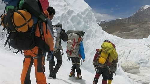 <div class="paragraphs"><p>Climbers descend from camp one to base camp at Mount Everest.</p></div>