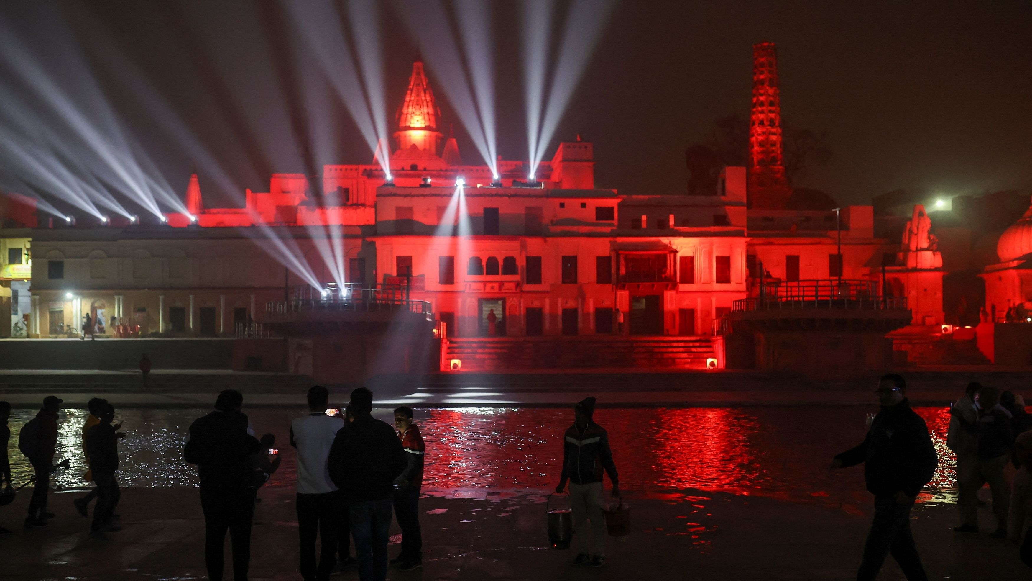 <div class="paragraphs"><p>Devotees take pictures on their mobile of the temples illuminated with lights after evening prayers on the banks of the Sarayu river in Ayodhya.</p></div>