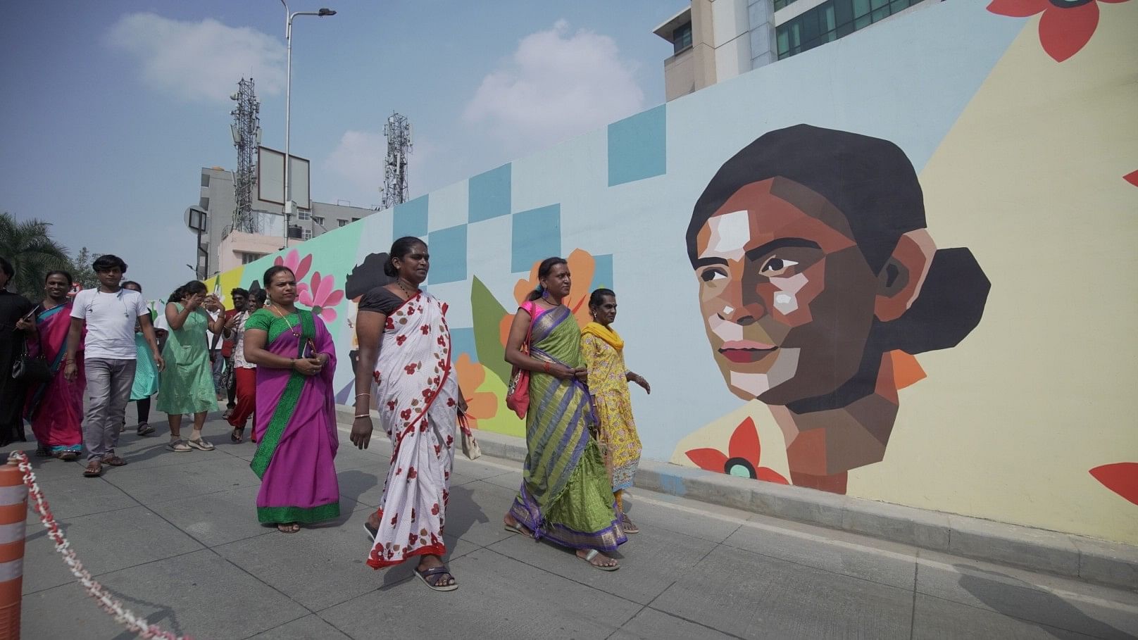 <div class="paragraphs"><p>Transgender women walk down the underpass painted with potraits of transgender people, displaying a message of social inclusivity. </p></div>