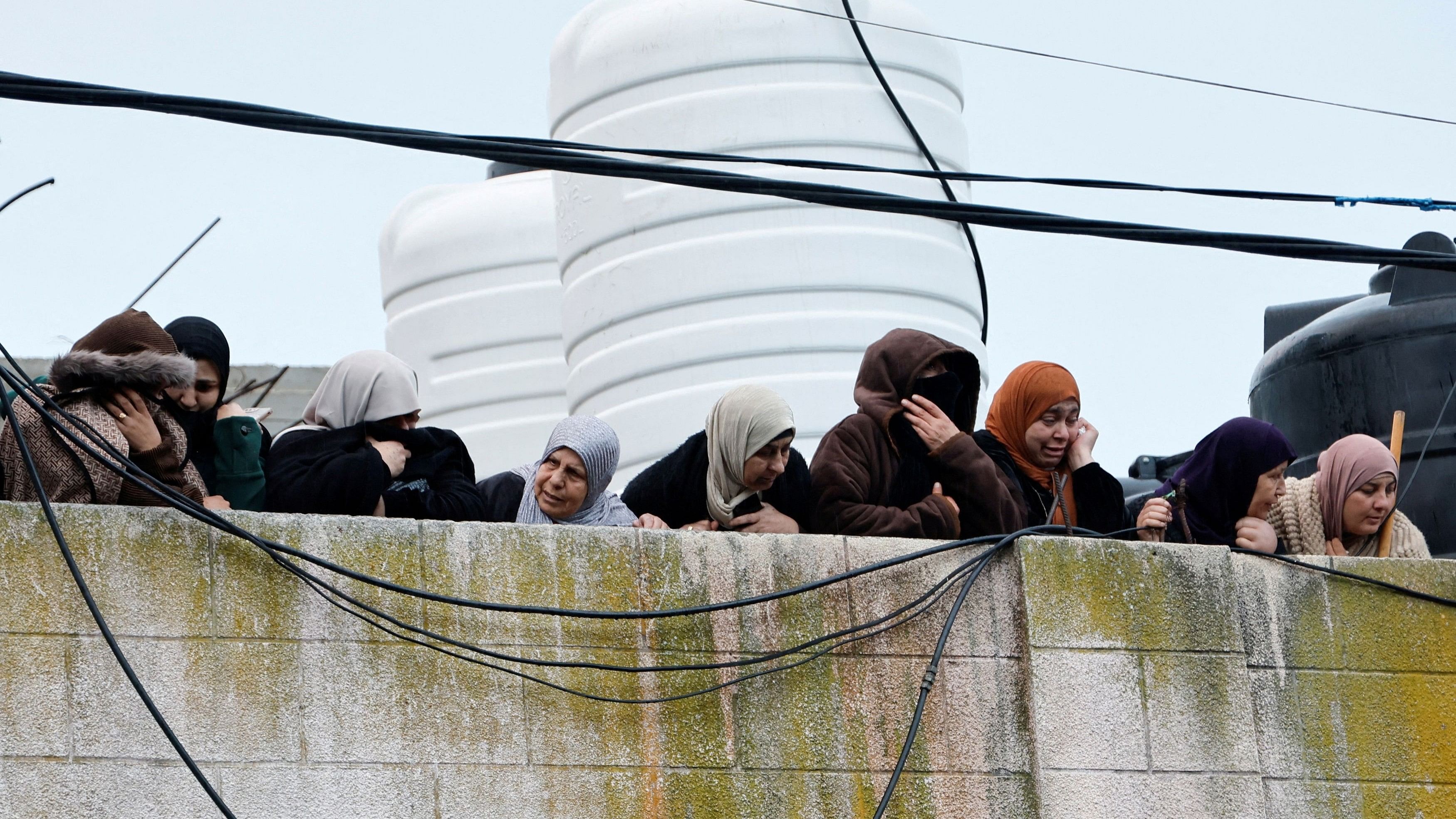 <div class="paragraphs"><p>Women observe from a rooftop after a raid in Occupied West Bank on January 11, 2024.</p></div>