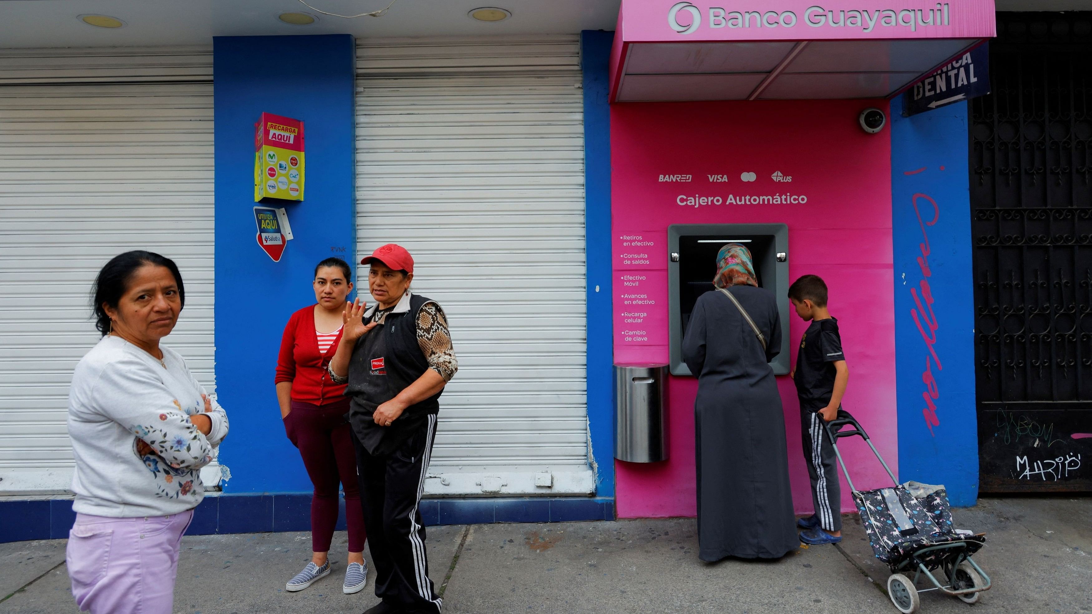 <div class="paragraphs"><p>People stand outside a closed business, following a violence outbreak a day after Ecuador's President Daniel Noboa declared a 60-day state of emergency following the disappearance of Adolfo Macias, leader of the Los Choneros criminal gang from the prison where he was serving a 34-year sentence, in Quito, Ecuador, January 9, 2024.</p></div>
