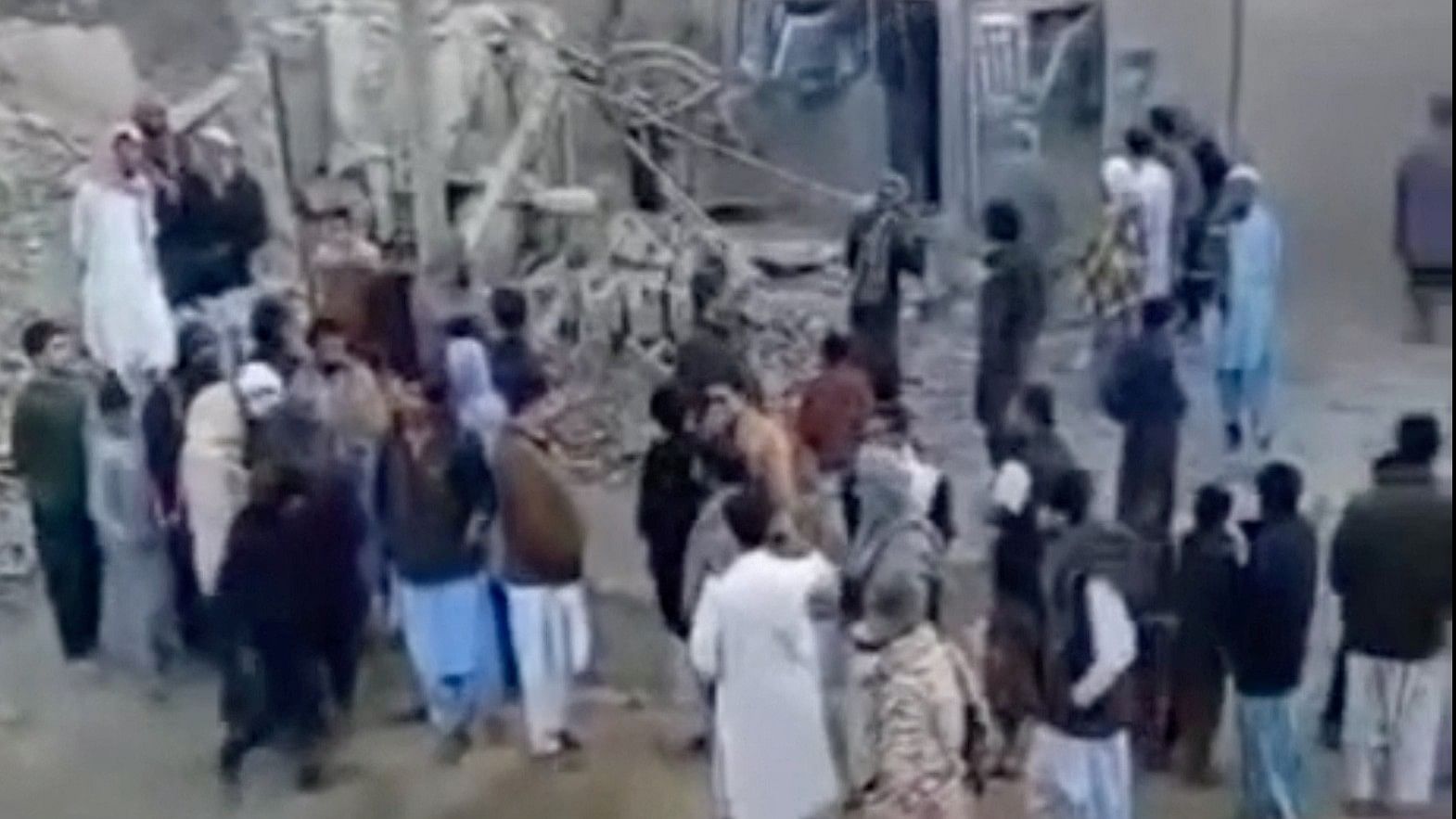 <div class="paragraphs"><p>People gather in the aftermath of Pakistan’s military strike on a village&nbsp;in Sistan-Baluchestan province in Iran. </p></div>