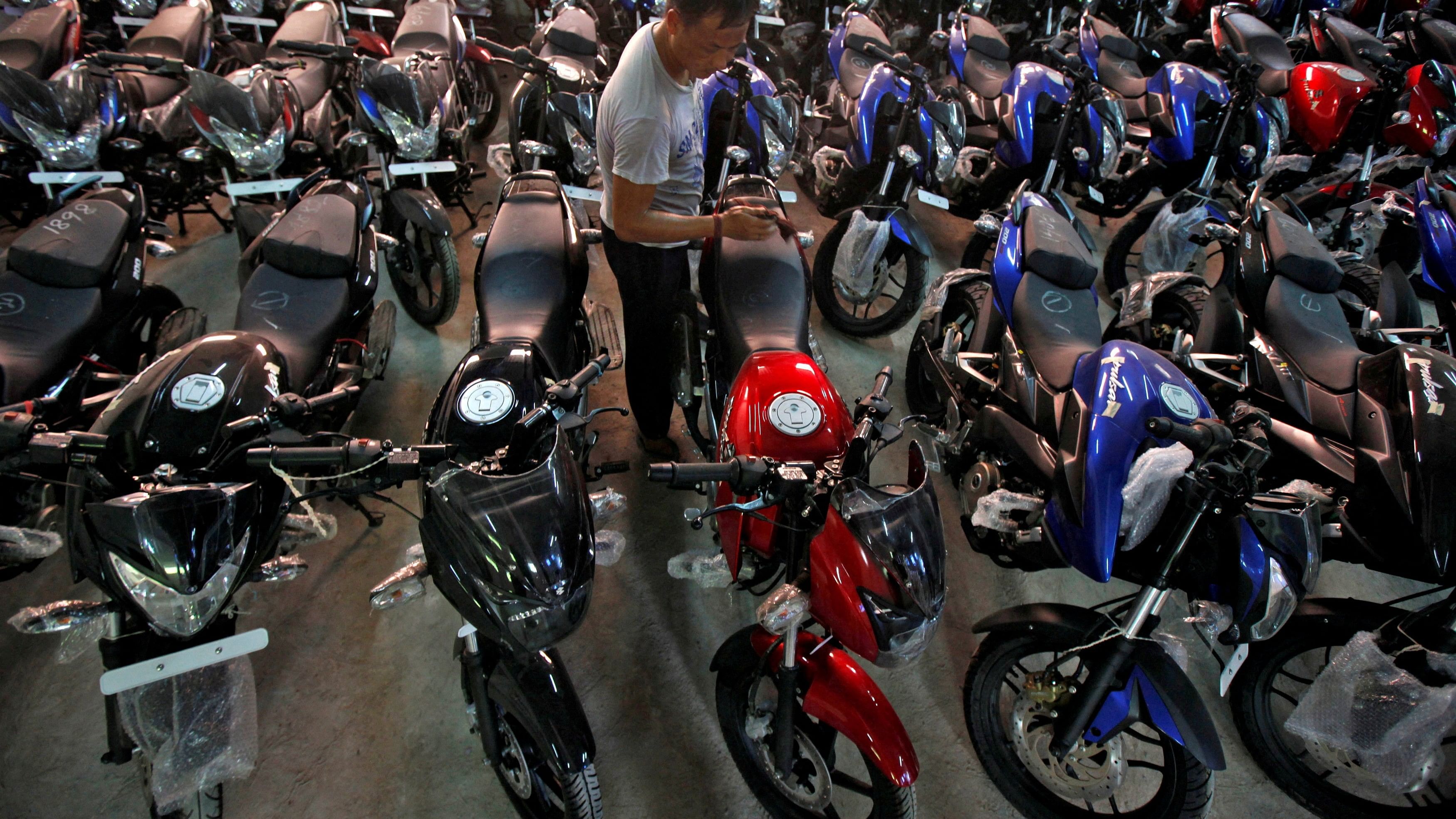 <div class="paragraphs"><p>Motorcycles being cleaned in a Bajaj showroom.</p></div>