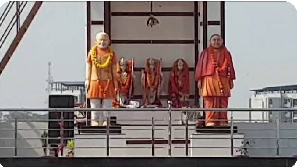 <div class="paragraphs"><p>Statues of PM Modi and Yogi Adityanath outside rooftop shrine.</p></div>