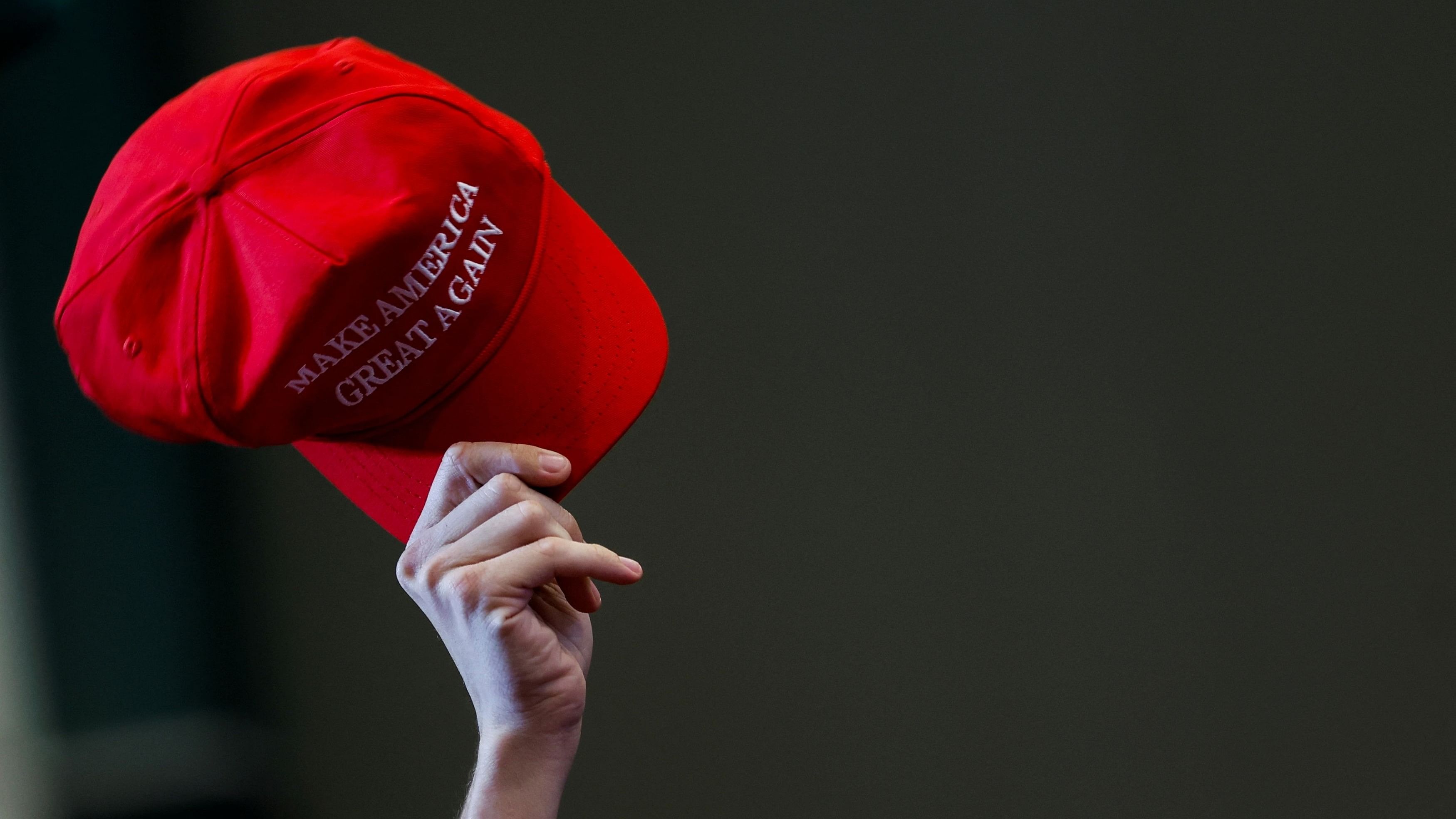 <div class="paragraphs"><p>A supporter holds up a Make America Great Again hat.</p></div>