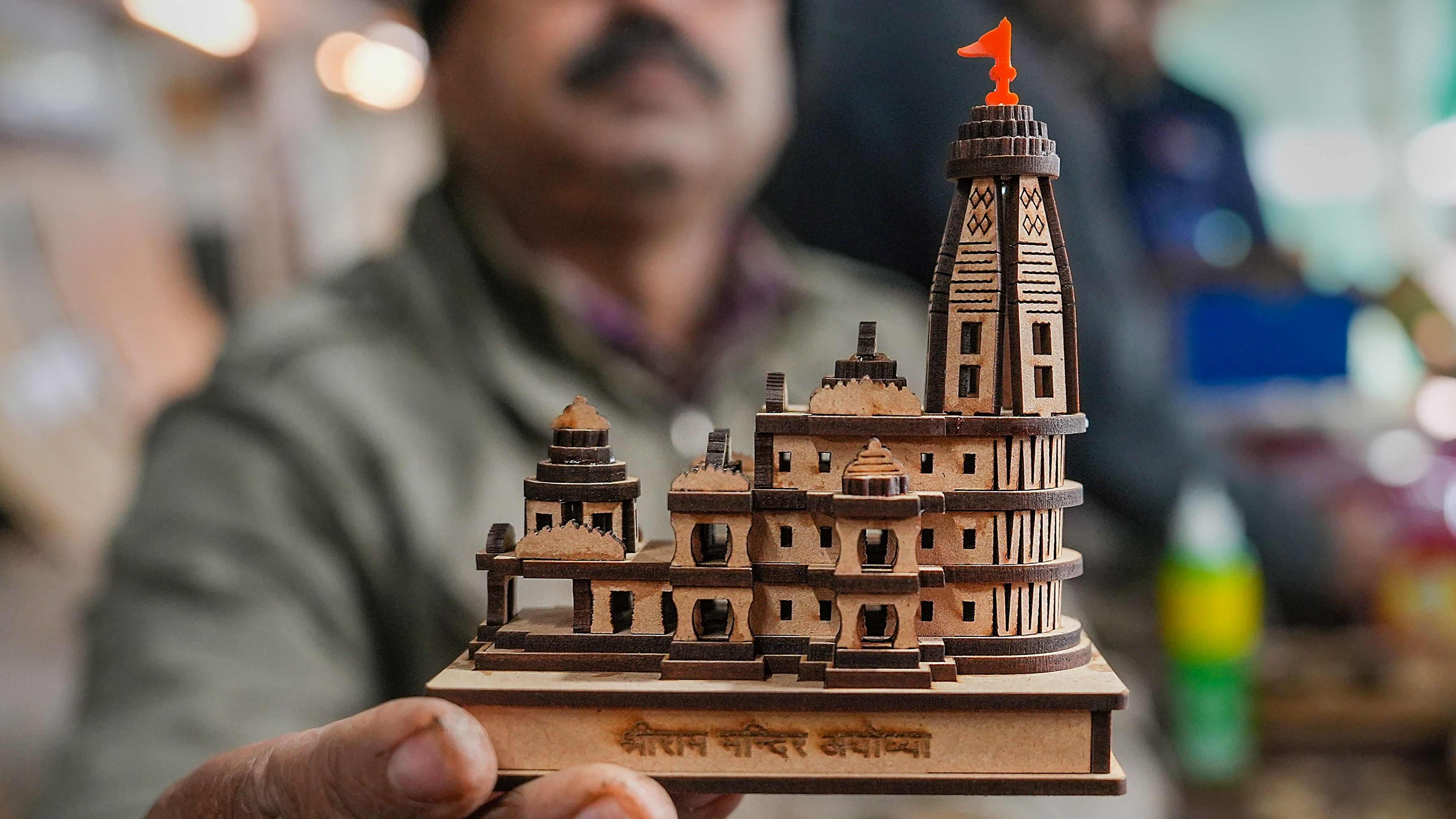 <div class="paragraphs"><p>A staffer at a manufacturing unit displays a model of the Shri Ram Janmabhoomi Temple, at Faizabad in Ayodhya district, Monday, Jan. 1, 2024. </p></div>