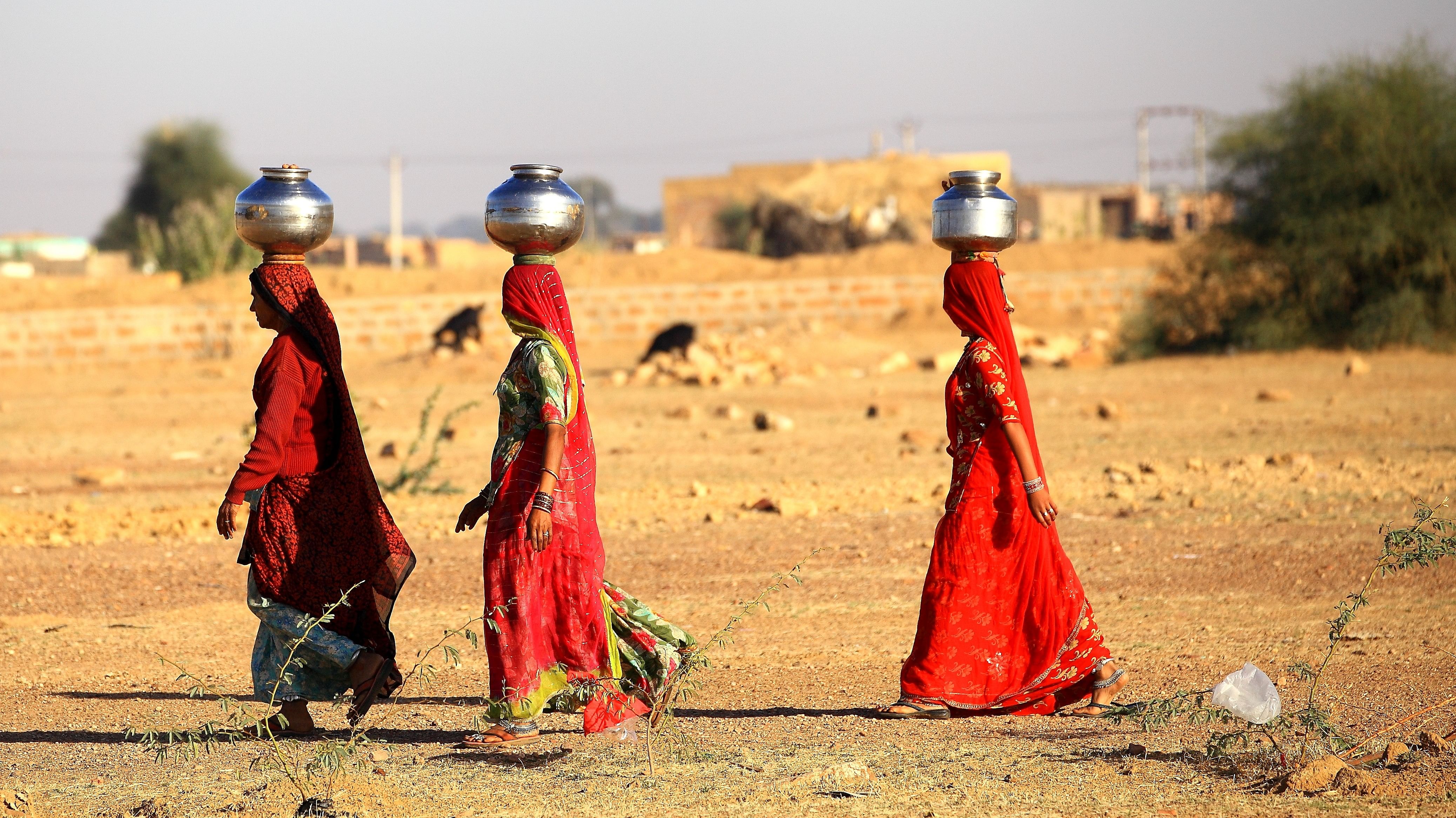 <div class="paragraphs"><p>Representative image showing omen lugging a water pot on their head in Rajasthan.</p></div>