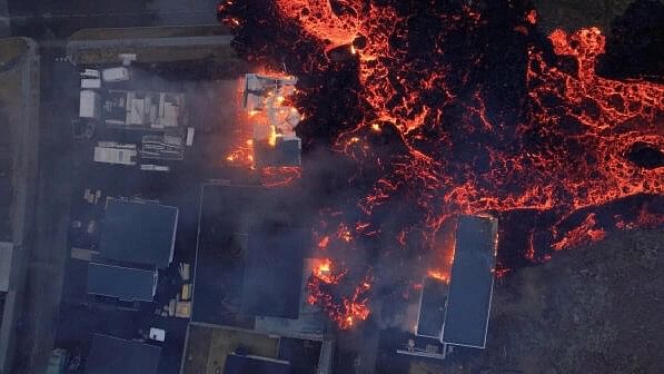 <div class="paragraphs"><p>Lava flows from a volcano as houses burn in Grindavik, Iceland.</p></div>