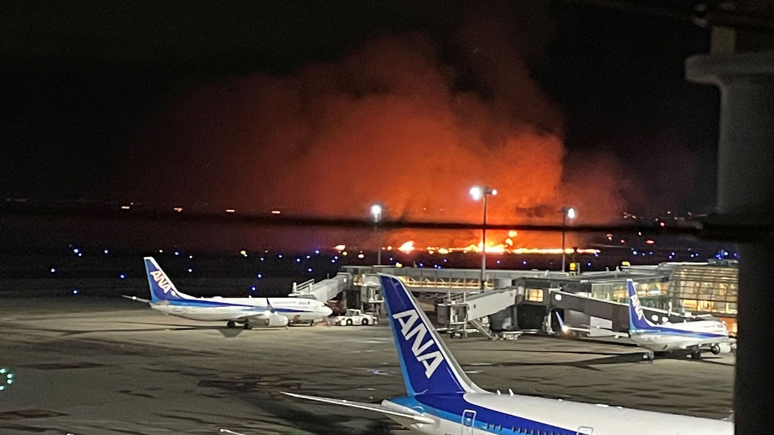 <div class="paragraphs"><p>Smoke billows and flames rise after a Japan Airlines (JAL) plane collided with a Coast Guard aircraft on the ground, at Tokyo's Haneda airport, Japan, January 2, 2024 in this image obtained from social media.</p></div>