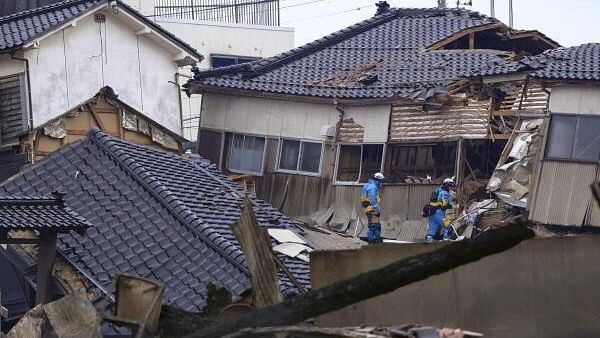 <div class="paragraphs"><p>Police officers search missing people at a collapsed house caused by an earthquake in Wajima, Ishikawa prefecture, Japan.</p></div>