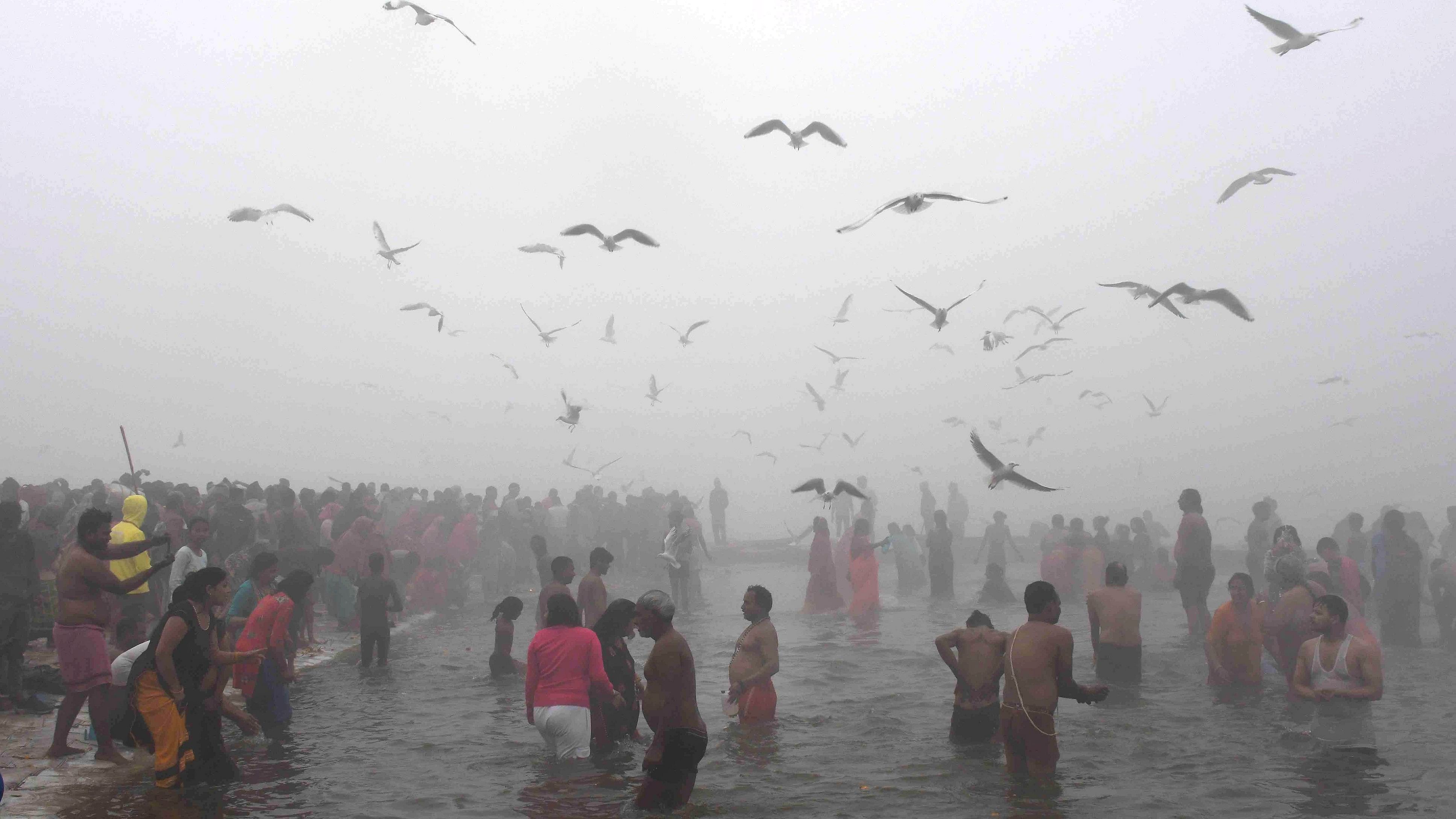 <div class="paragraphs"><p>Devotees take a holy dip in the Ganga river amid fog on a cold winter morning on the occasion of Makar Sankranti during the annual religious 'Magh Mela' festival at Sangam, in Prayagraj.&nbsp;</p></div>