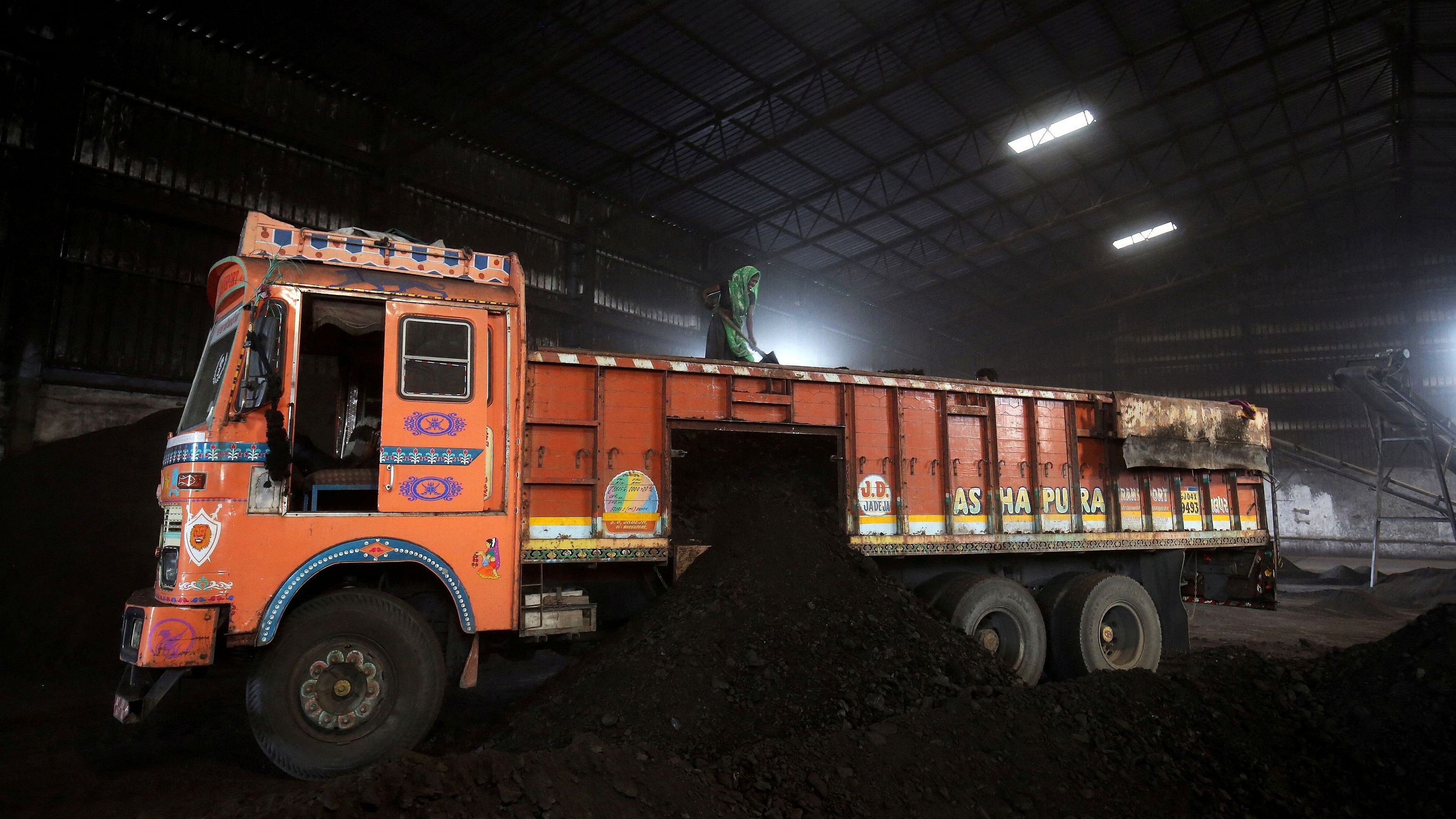 <div class="paragraphs"><p> A worker shovels coal in a supply truck at a yard on the outskirts of Ahmedabad, India.</p></div>