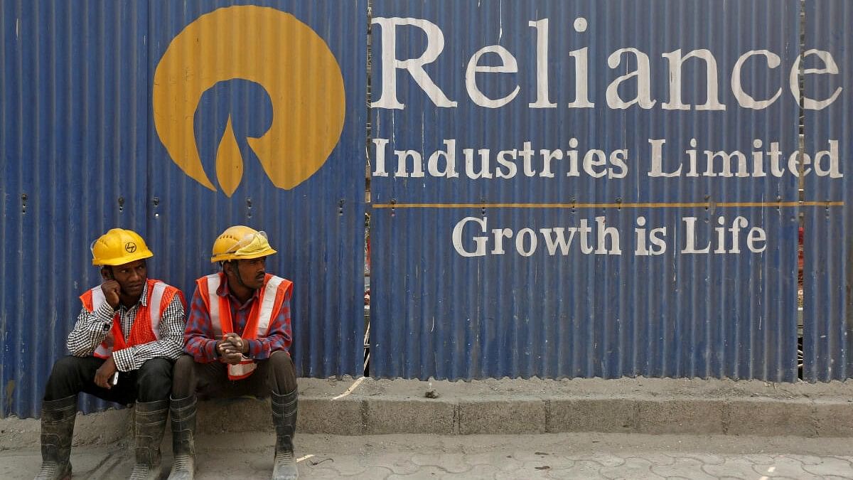 <div class="paragraphs"><p> Labourers rest in front of an advertisement of Reliance Industries Limited at a construction site in Mumbai.</p></div>