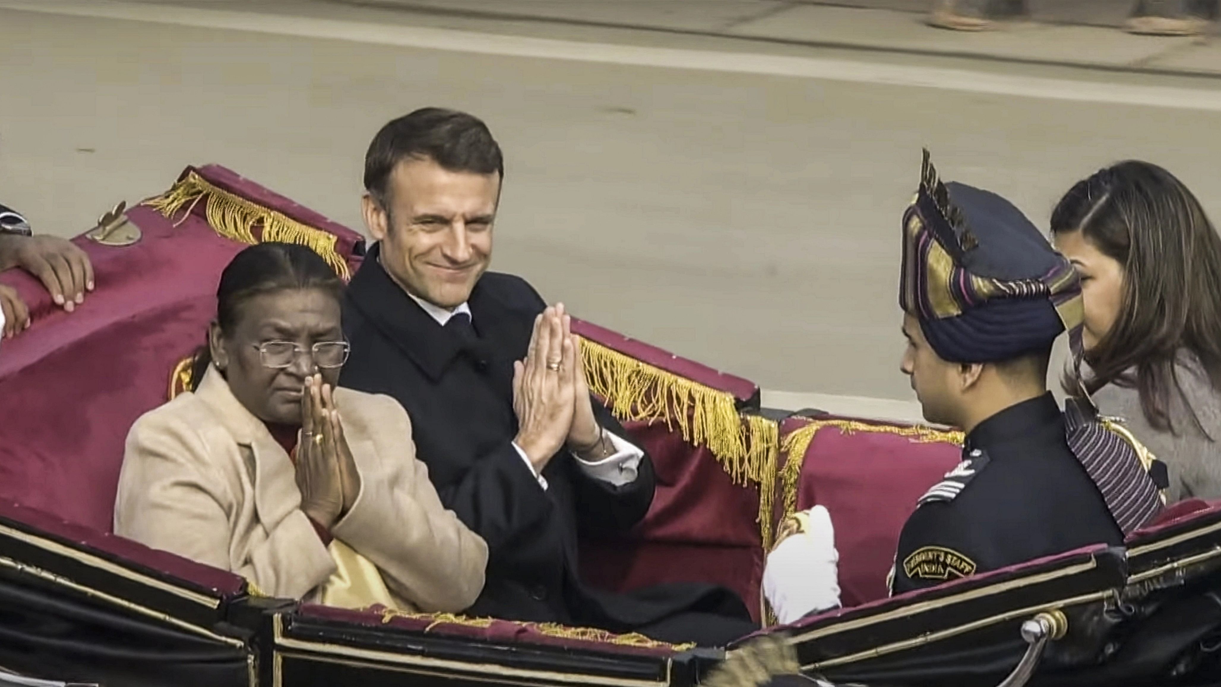 <div class="paragraphs"><p>President Droupadi Murmu with chief guest French President Emmanuel Macron arrives during the 75th Republic Day function at the Kartavya Path, in New Delhi, Friday, January 26, 2024. </p></div>