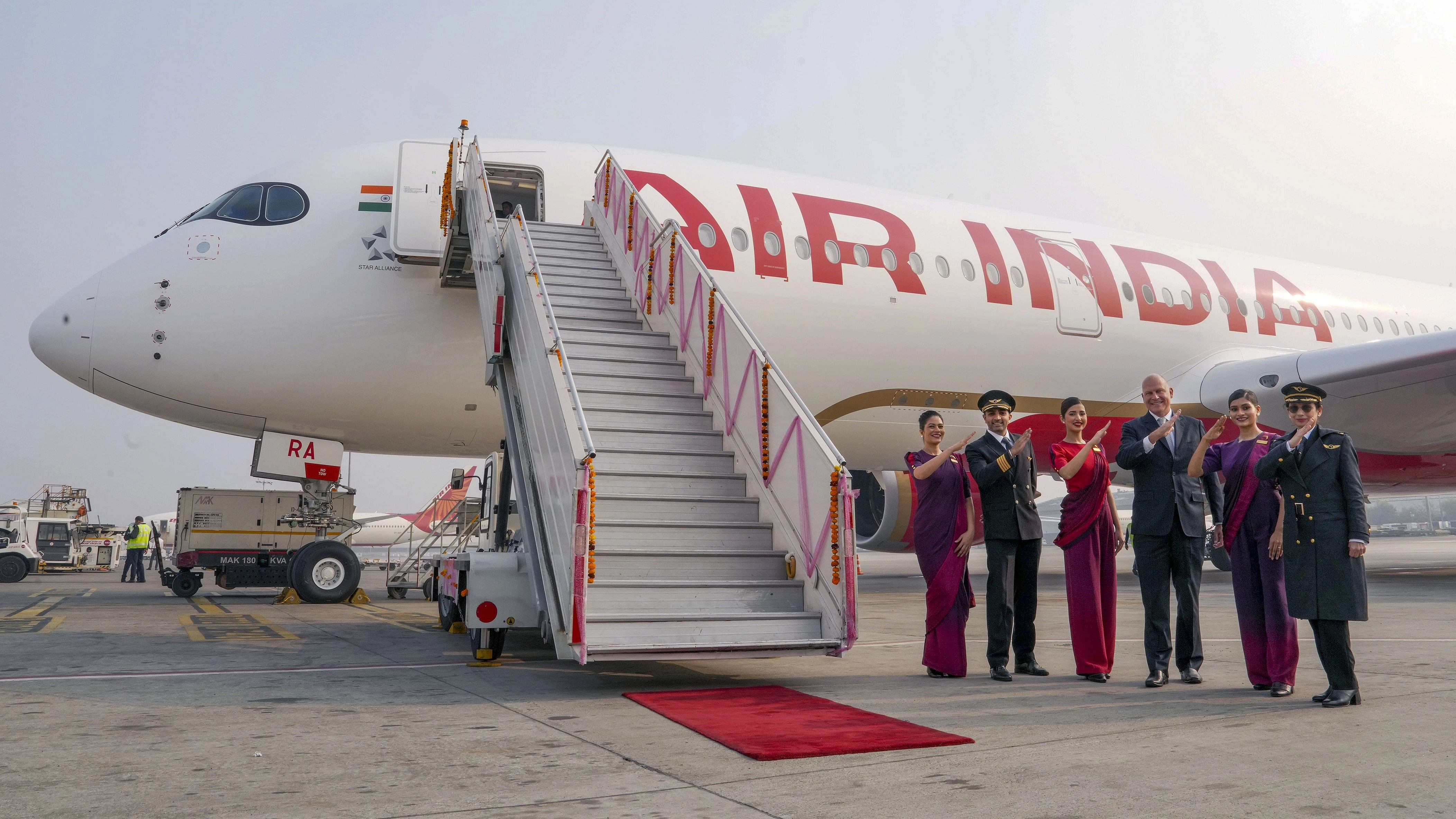 <div class="paragraphs"><p>Air India CEO and MD Campbell Wilson with cabin and cockpit crews poses with the newly-inducted Airbus' wide-body A350-900 aircraft upon its touchdown at the Indira Gandhi International Airport, in New Delhi, Saturday, Dec. 23, 2023. </p></div>