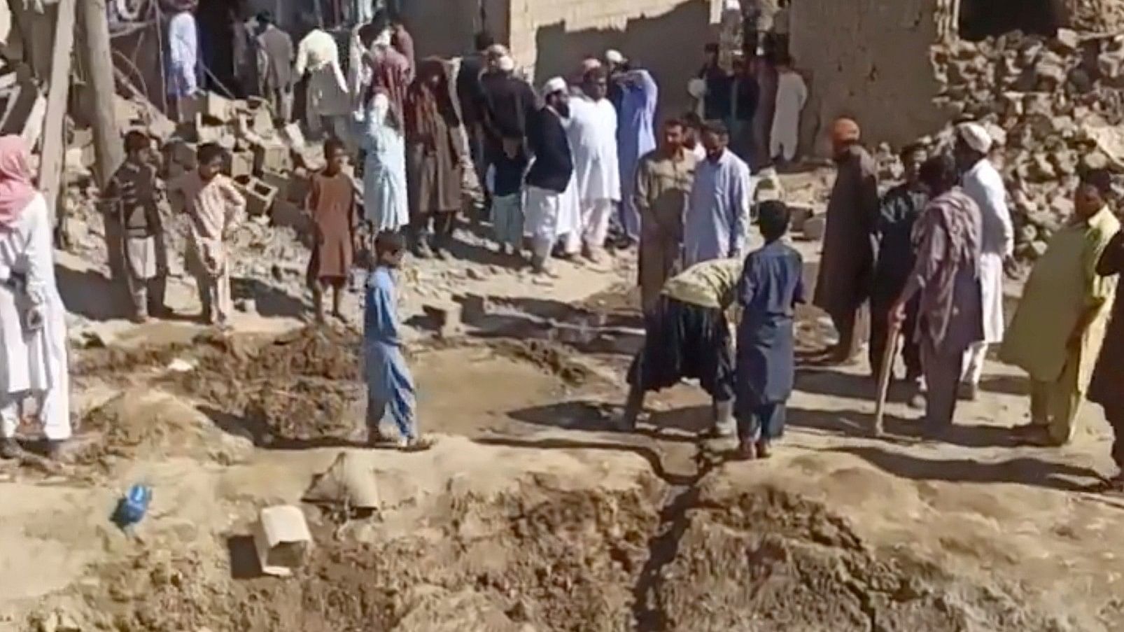 <div class="paragraphs"><p>People gather near rubble in the aftermath of Pakistan's military strike on an Iranian village near Saravan, Sistan and Baluchestan Province, Iran, January 18, 2024.</p></div>