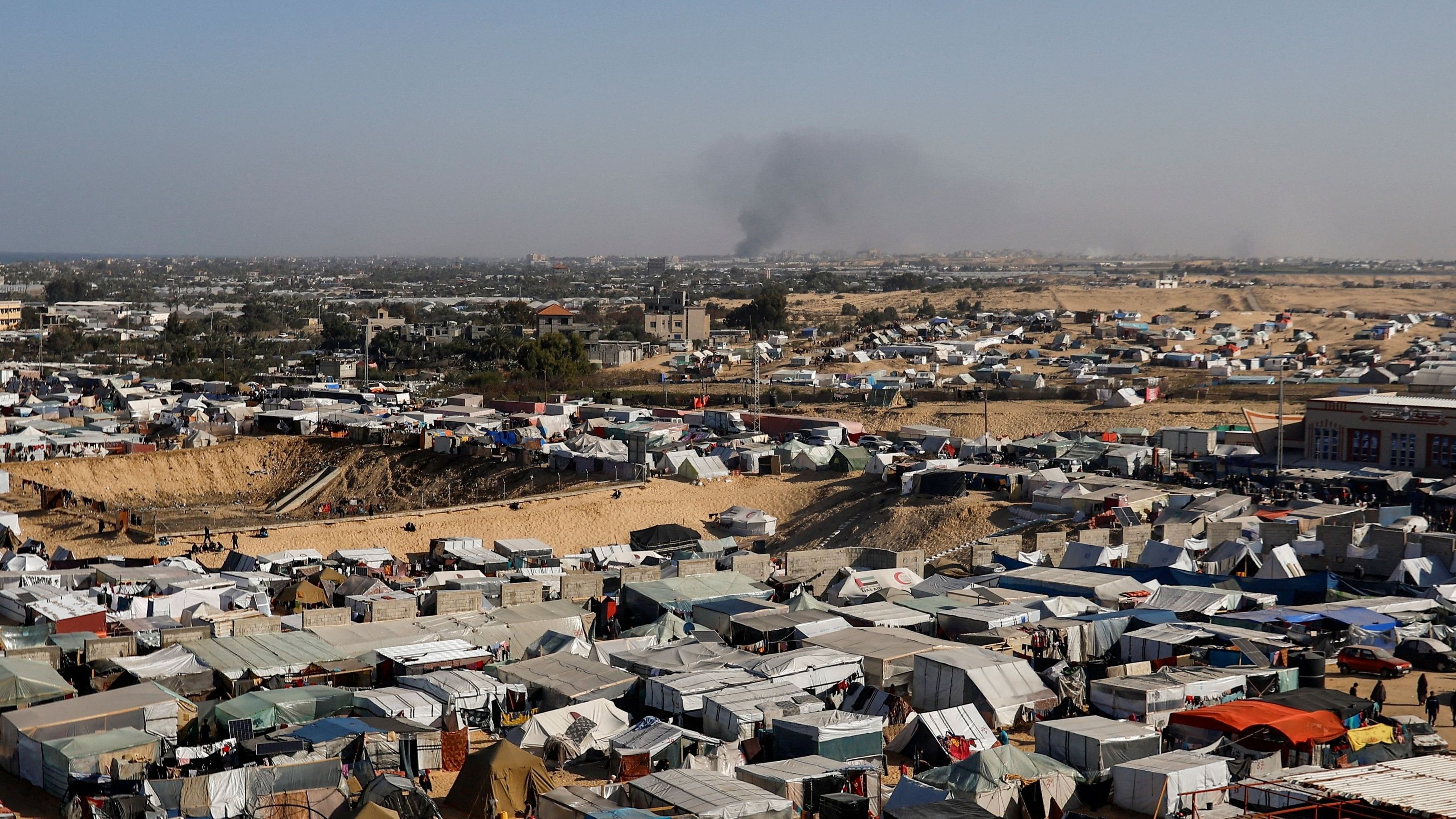 <div class="paragraphs"><p>A general view of a tent camp housing displaced Palestinians, as smoke rises in the distance due to an Israeli ground operation in Khan Younis, amid the ongoing conflict between Israel and the Palestinian Islamist group Hamas, as seen Rafah in the southern Gaza Strip, January 22, 2024. </p></div>