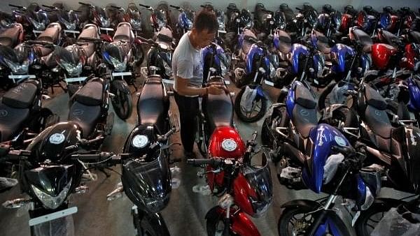 <div class="paragraphs"><p>A worker cleans a Bajaj motorcycle at a Bajaj showroom in Kolkata.</p></div>