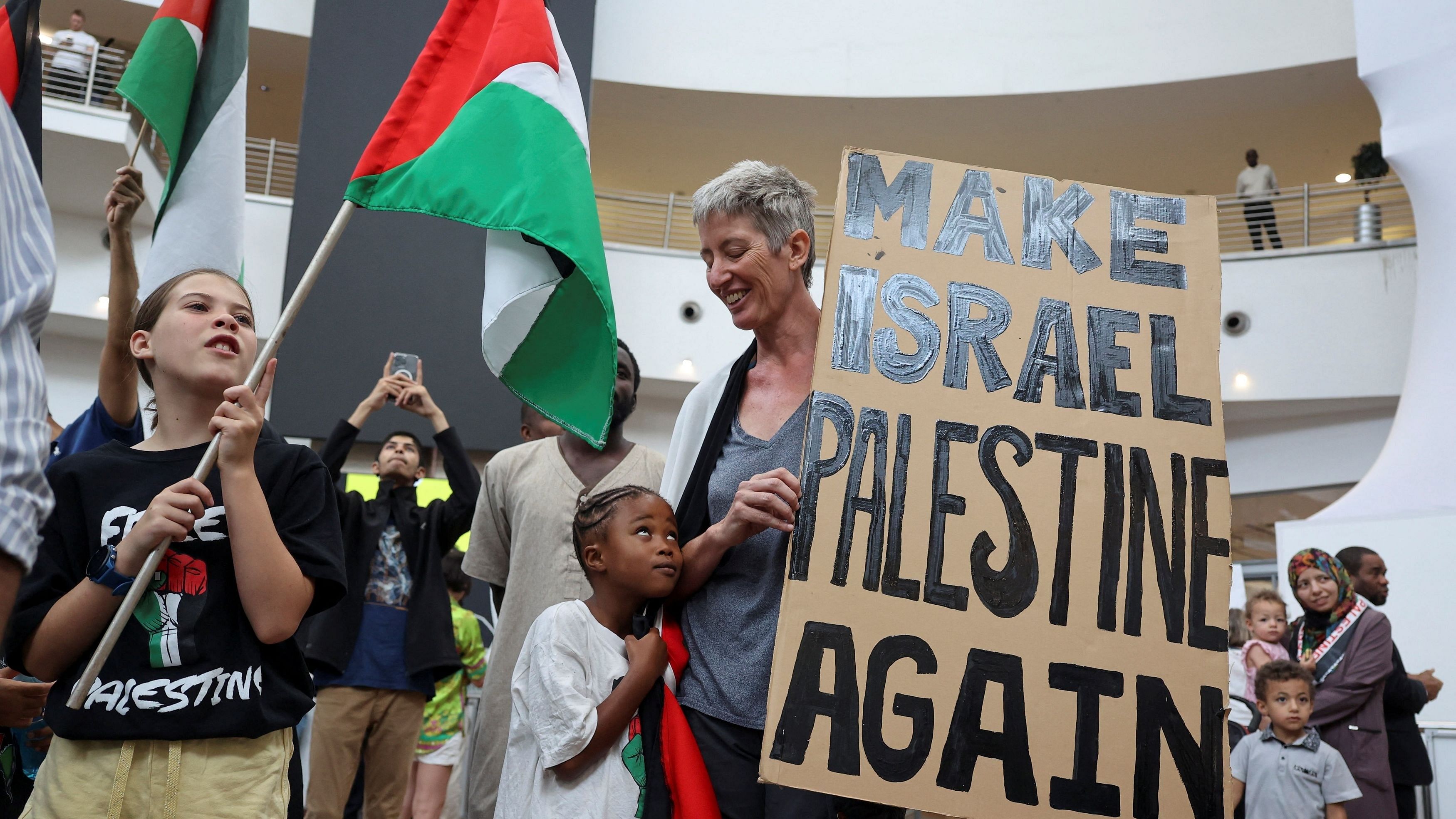 <div class="paragraphs"><p>People gather as they wait for South Africa's Minister of Justice Ronald Lamola and other members of the South African legal team representing South Africa's case against Israel at the International Court of Justice  arrival at OR Tambo International airport, after their request for emergency measures to order Israel to stop its military actions in Gaza, in Johannesburg, South Africa, January 14.</p></div>