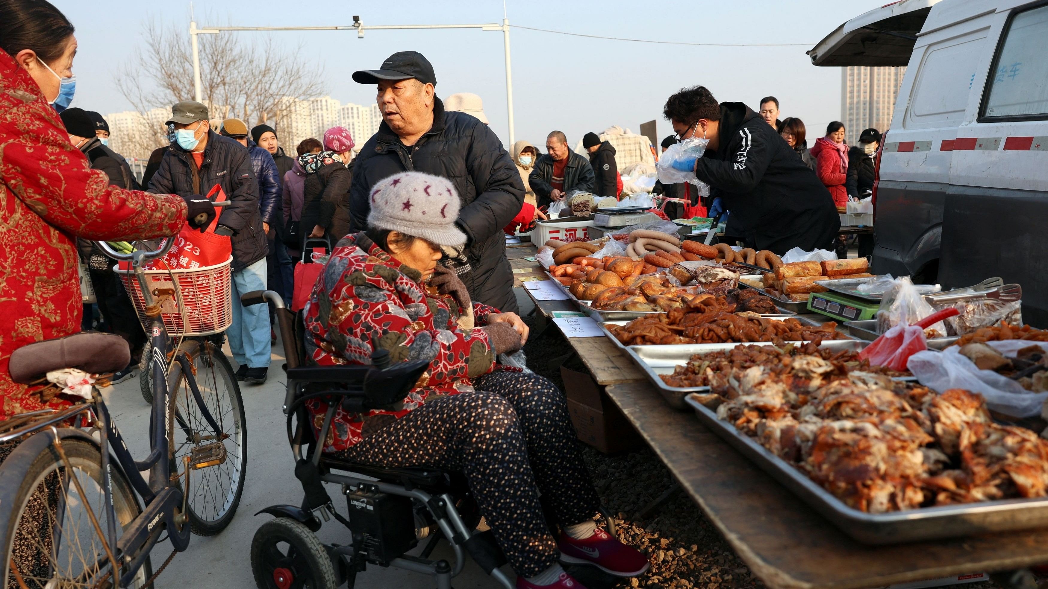<div class="paragraphs"><p>Elderly people chat next to a food stall at an outdoor market in Beijing, China, January 12, 2024. </p></div>