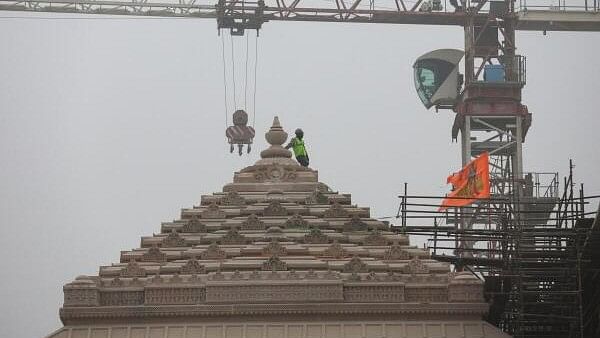 <div class="paragraphs"><p>A worker stands on a stone structure being carved at the under construction site of the Hindu Ram Temple in Ayodhya.</p></div>