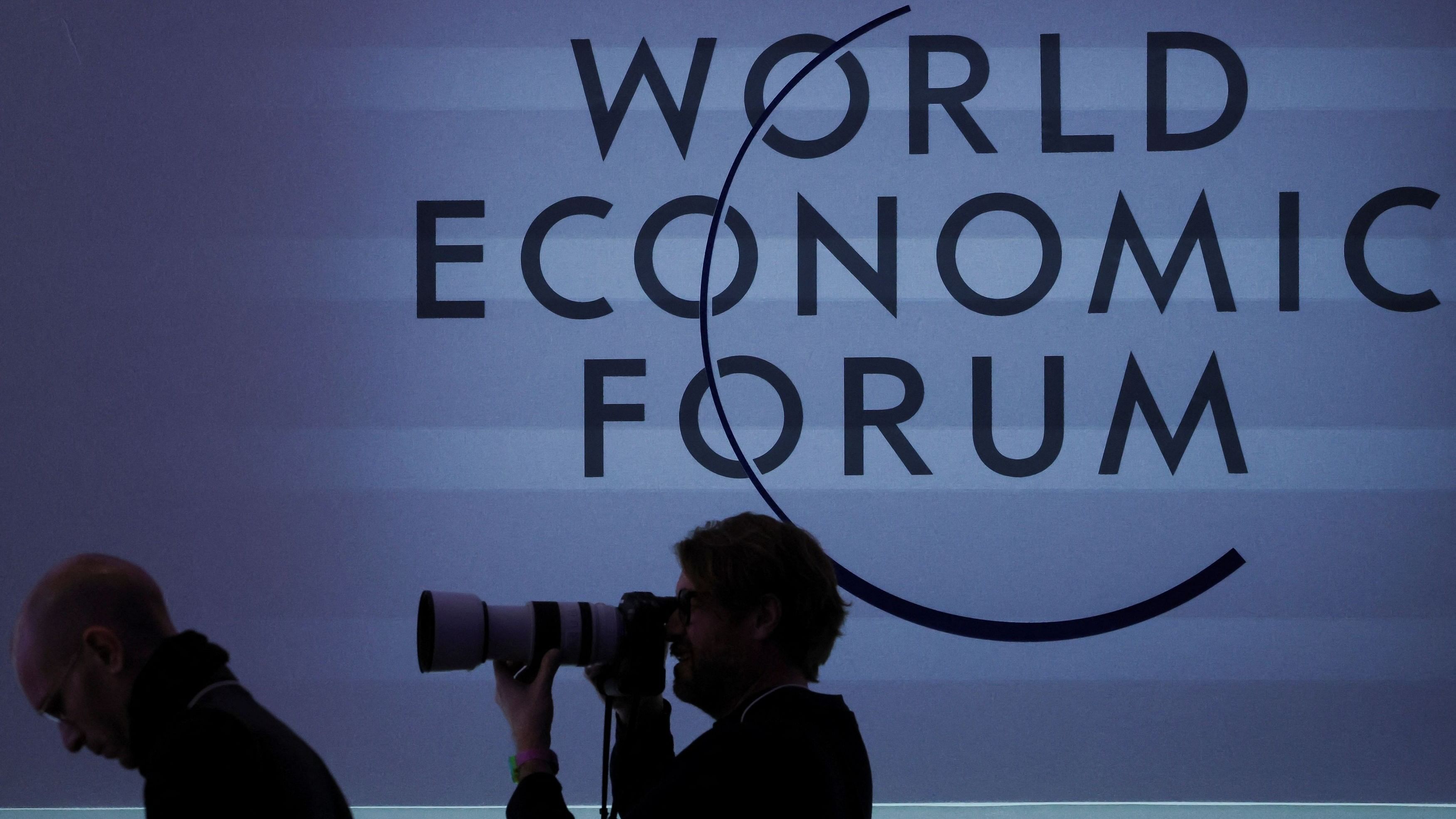 <div class="paragraphs"><p>A person takes a photo next to a logo during the 54th annual meeting of the World Economic Forum, in Davos, Switzerland, January 19, 2024. </p></div>