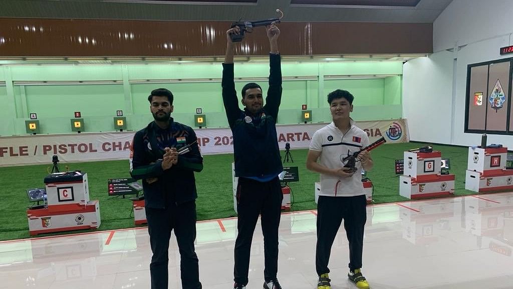 <div class="paragraphs"><p>Varun Tomar (C) scored 239.6 points to  win Olympic Quota and Gold medal for India in 10m Air Pistol Men event at Asian Qlympic Qualification. </p></div>