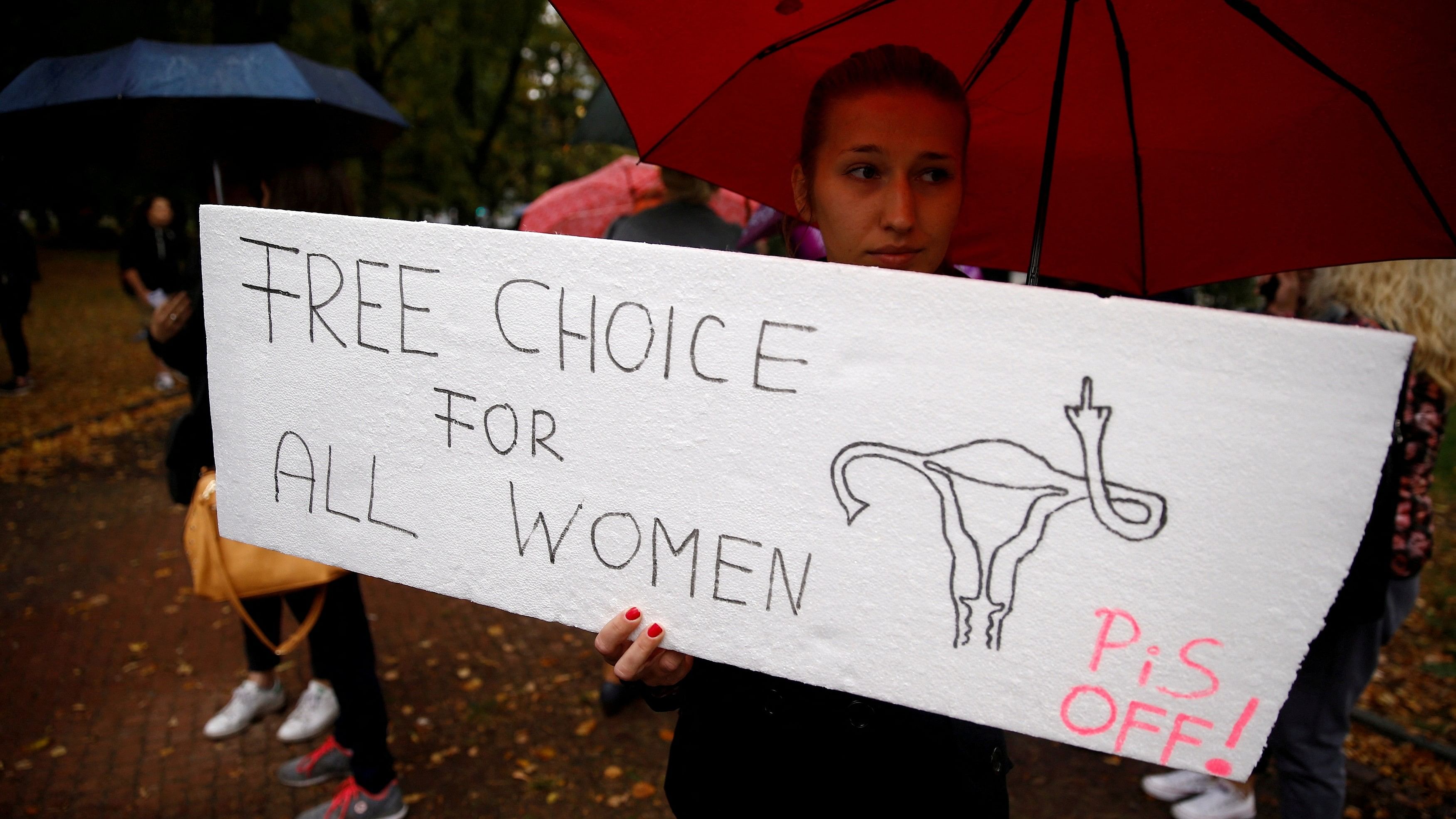 <div class="paragraphs"><p>A woman holds a placard in an abortion rights campaigners' demonstration.</p></div>