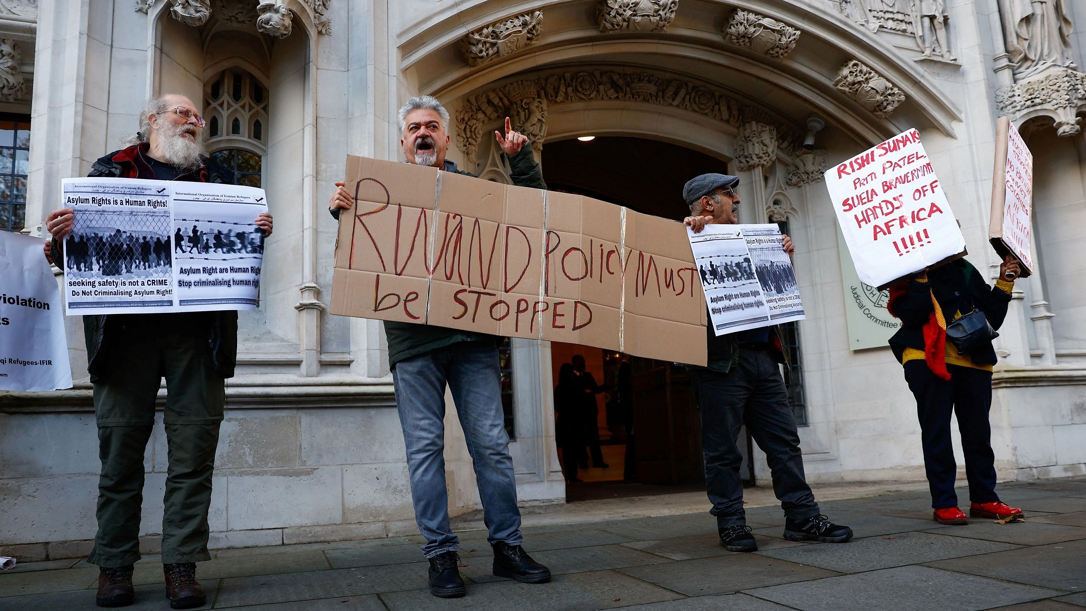 <div class="paragraphs"><p>In this file picture, protestors hold placards outside Supreme Court in London on the day the Supreme Court delivered its ruling on the government plan to deport migrants to Rwanda.</p></div>