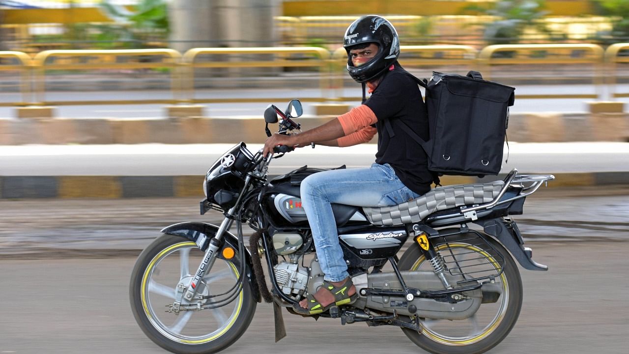 <div class="paragraphs"><p>A delivery executive zooms across the road to reach his destination in Bengaluru</p></div>