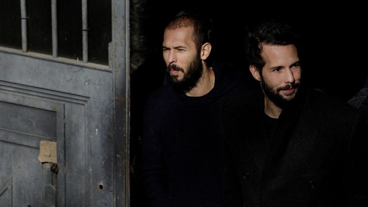 <div class="paragraphs"><p>Andrew Tate (left) and Tristan Tate are escorted by police officers outside the headquarters of the Bucharest Court of Appeal, in Bucharest, Romania. </p></div>