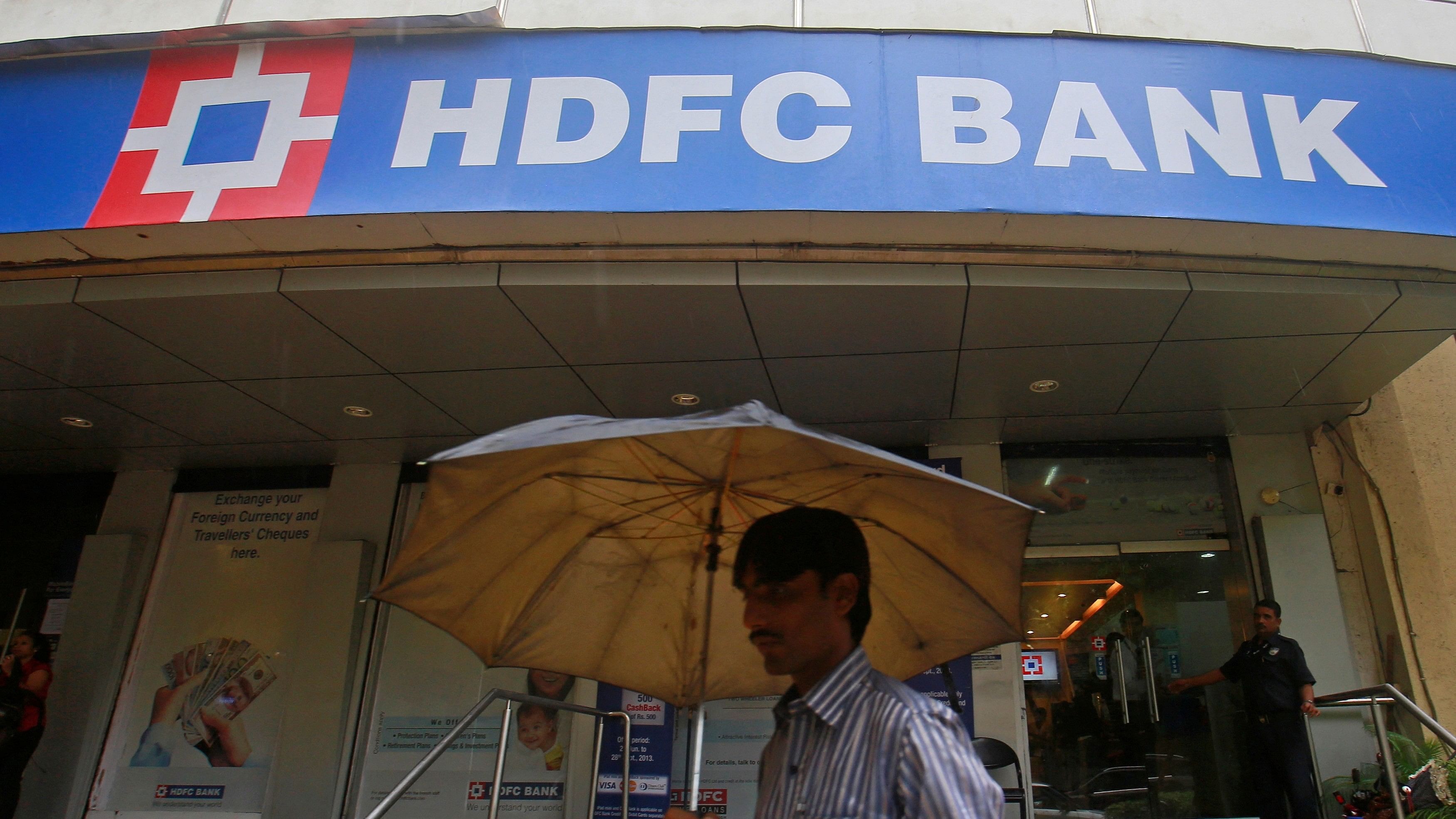 <div class="paragraphs"><p>A customer walks outside an HDFC Bank branch in Mumbai.</p></div>