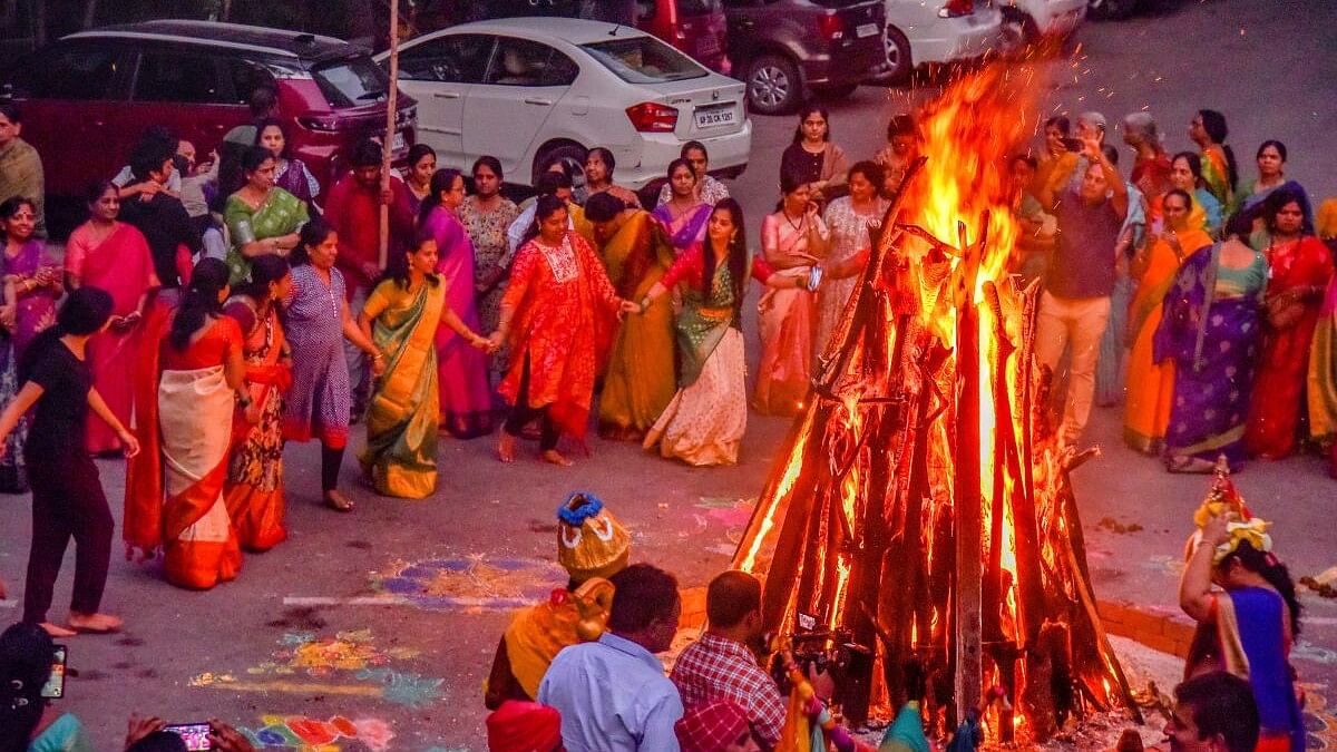 <div class="paragraphs"><p>People celebrate Bhogi, the first day of the four-day festival of Makar Sankranti.</p></div>