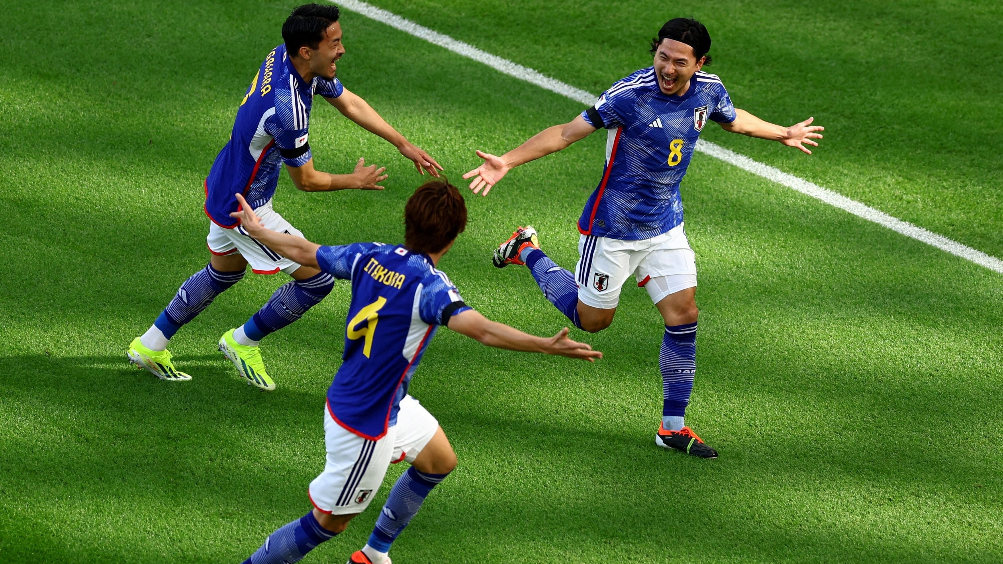 <div class="paragraphs"><p>Japan's Takumi Minamino celebrates scoring their first goal with Yukinari Sugawara and Kou Itakura.&nbsp;</p></div>