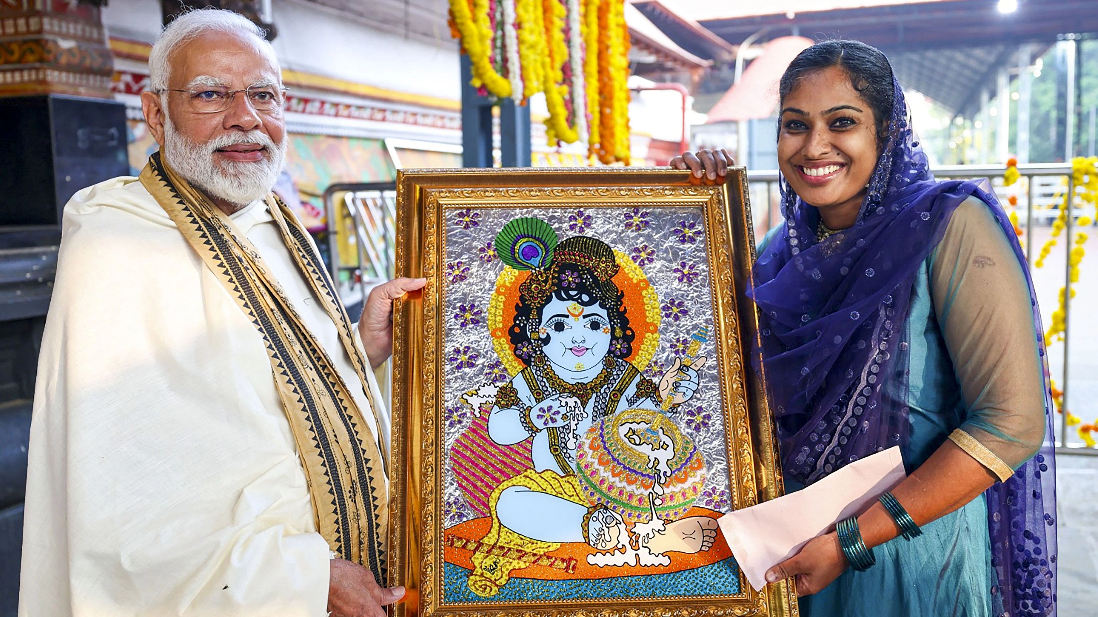 <div class="paragraphs"><p>Prime Minister Narendra Modi receives a lord Krishna painting from Jasna Salim. </p></div>