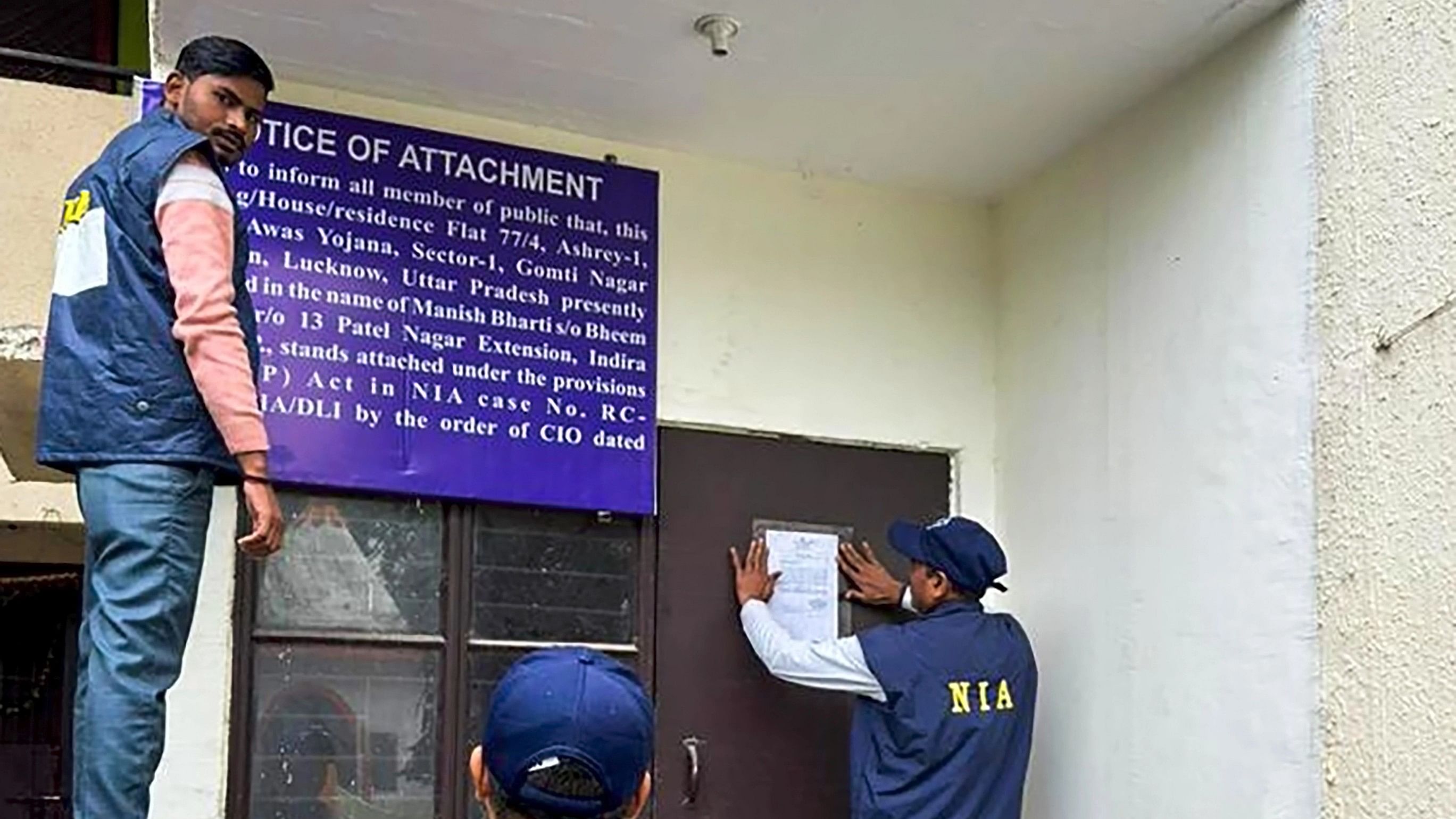 <div class="paragraphs"><p>National Investigation Agency (NIA) officers put up a notice of attachment at a property owned by members of gangster Lawrence Bishnoi’s crime syndicate, on Saturday, Jan. 6, 2024.</p></div>