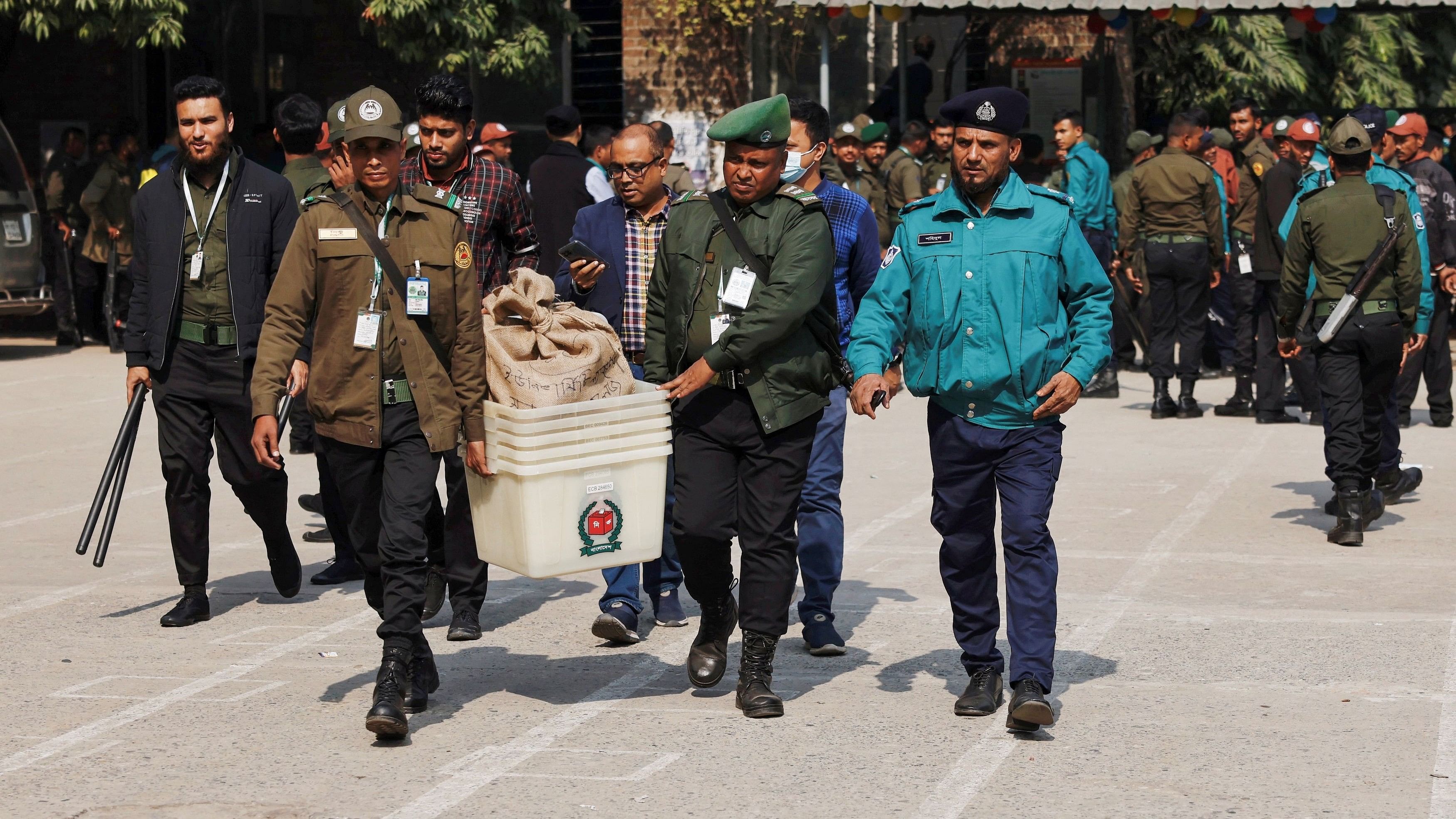 <div class="paragraphs"><p>Officials carry ballot boxes for distribution to the voting centres as part of election preparation, a day ahead of the general election in Dhaka, Bangladesh, January 6, 2024. </p></div>