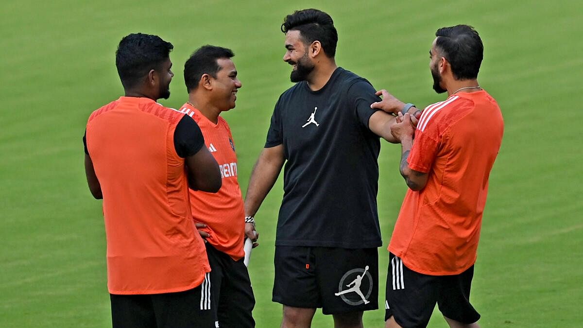 <div class="paragraphs"><p>Rishabh Pant shares a lighter moment with Virat Kohli and other team-mates during a practice session at M Chinnaswamy Stadium in Bengaluru.</p></div>