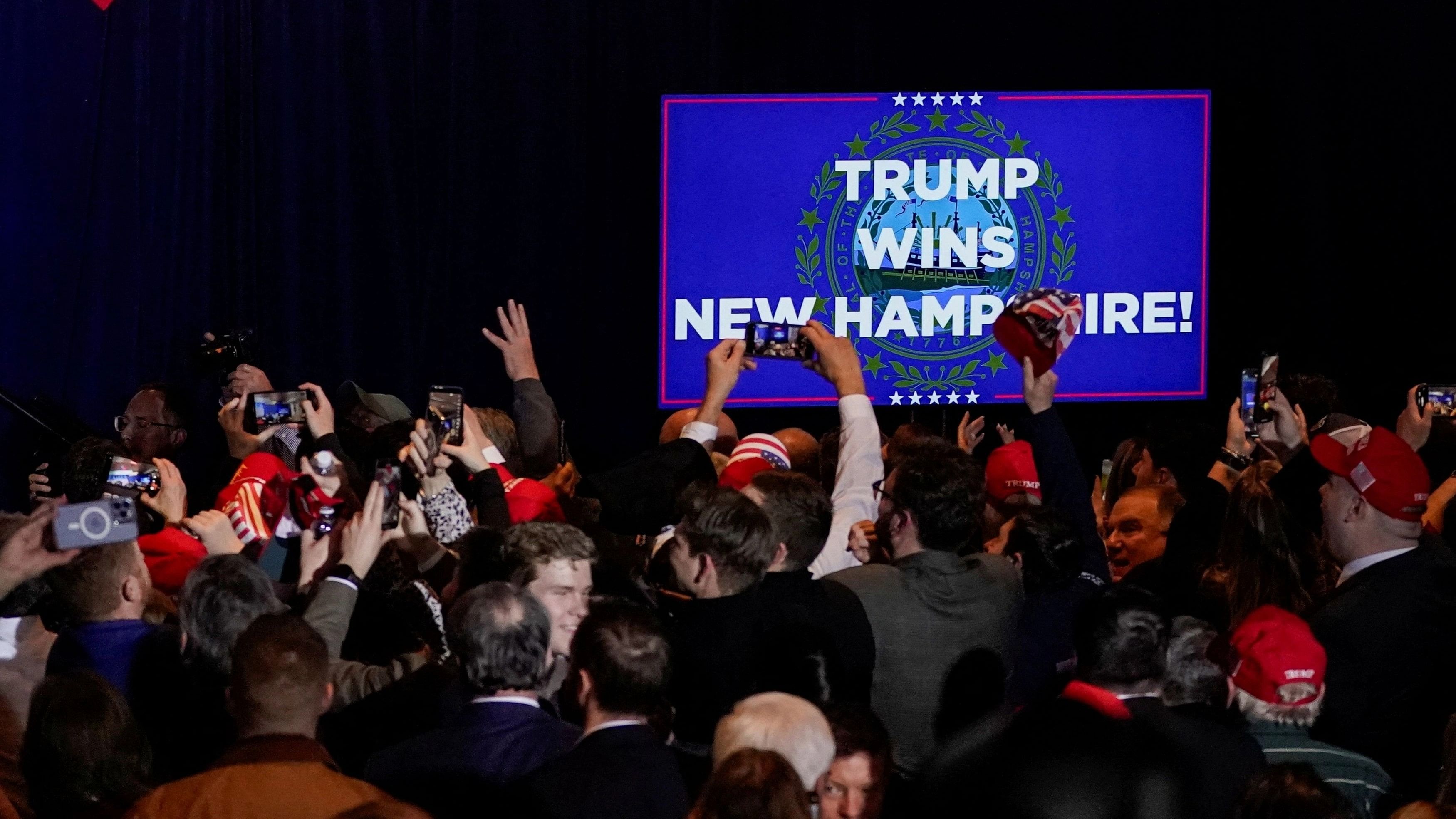 <div class="paragraphs"><p>Supporters react after major news organisations project that Republican presidential candidate and former US President Donald Trump wins, during a New Hampshire presidential primary election night watch party in Nashua, New Hampshire, US.</p></div>