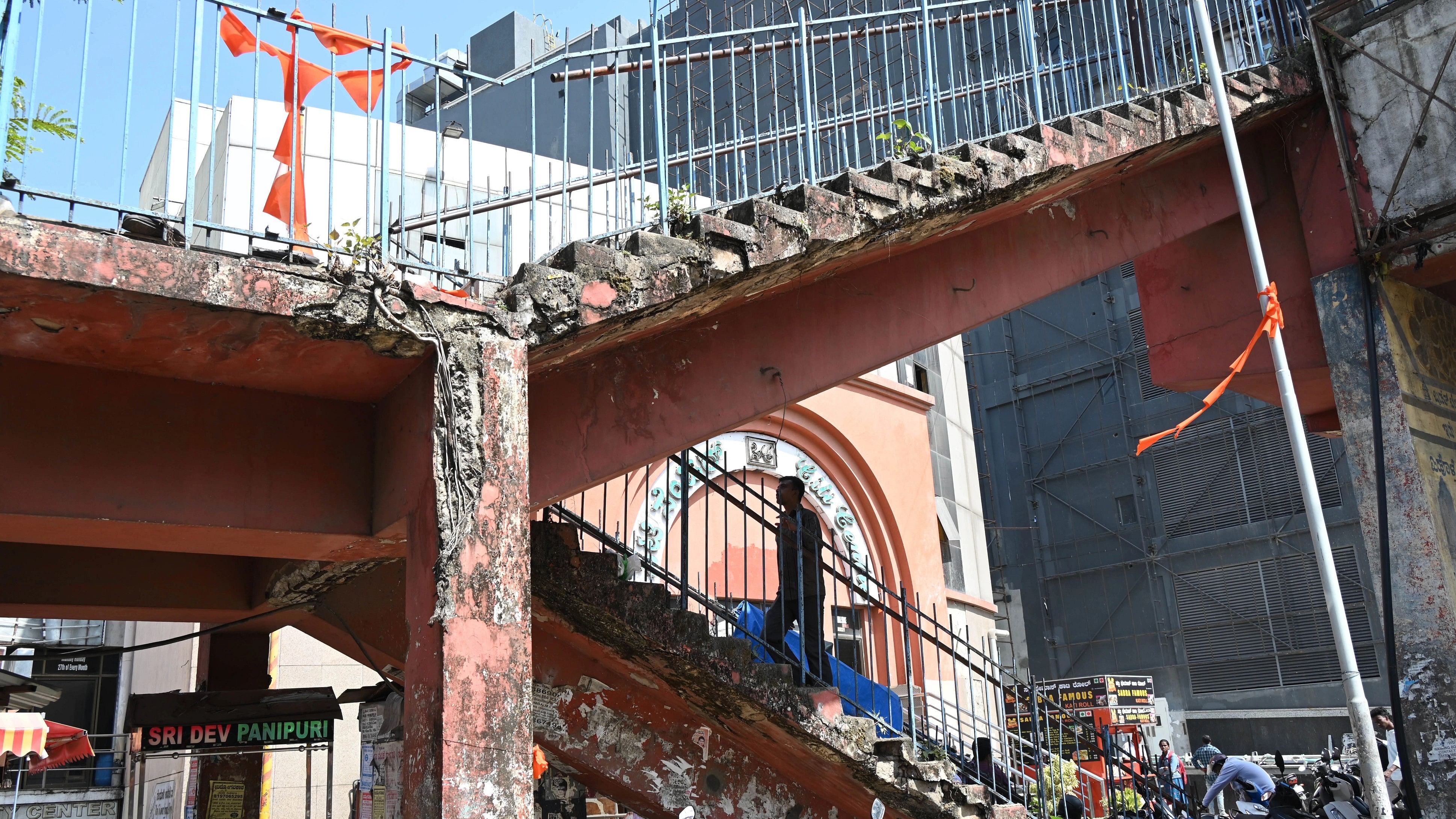 Cracked bricks and structural damage are evident in the skywalk on KG Road in Bengaluru on Saturday.