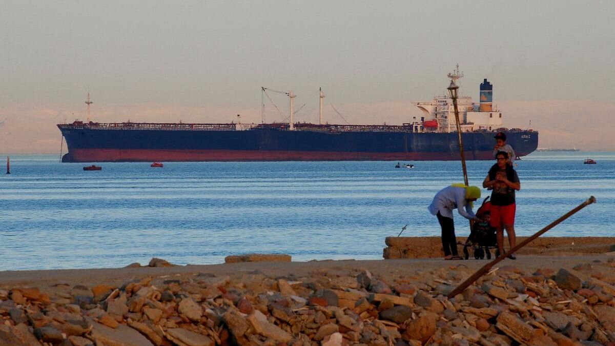 <div class="paragraphs"><p>People walk on the beach as a container ship crosses the Gulf of Suez towards the Red Sea before entering the Suez Canal, in El Ain El Sokhna in Suez, east of Cairo, Egypt April 24, 2017.</p></div>