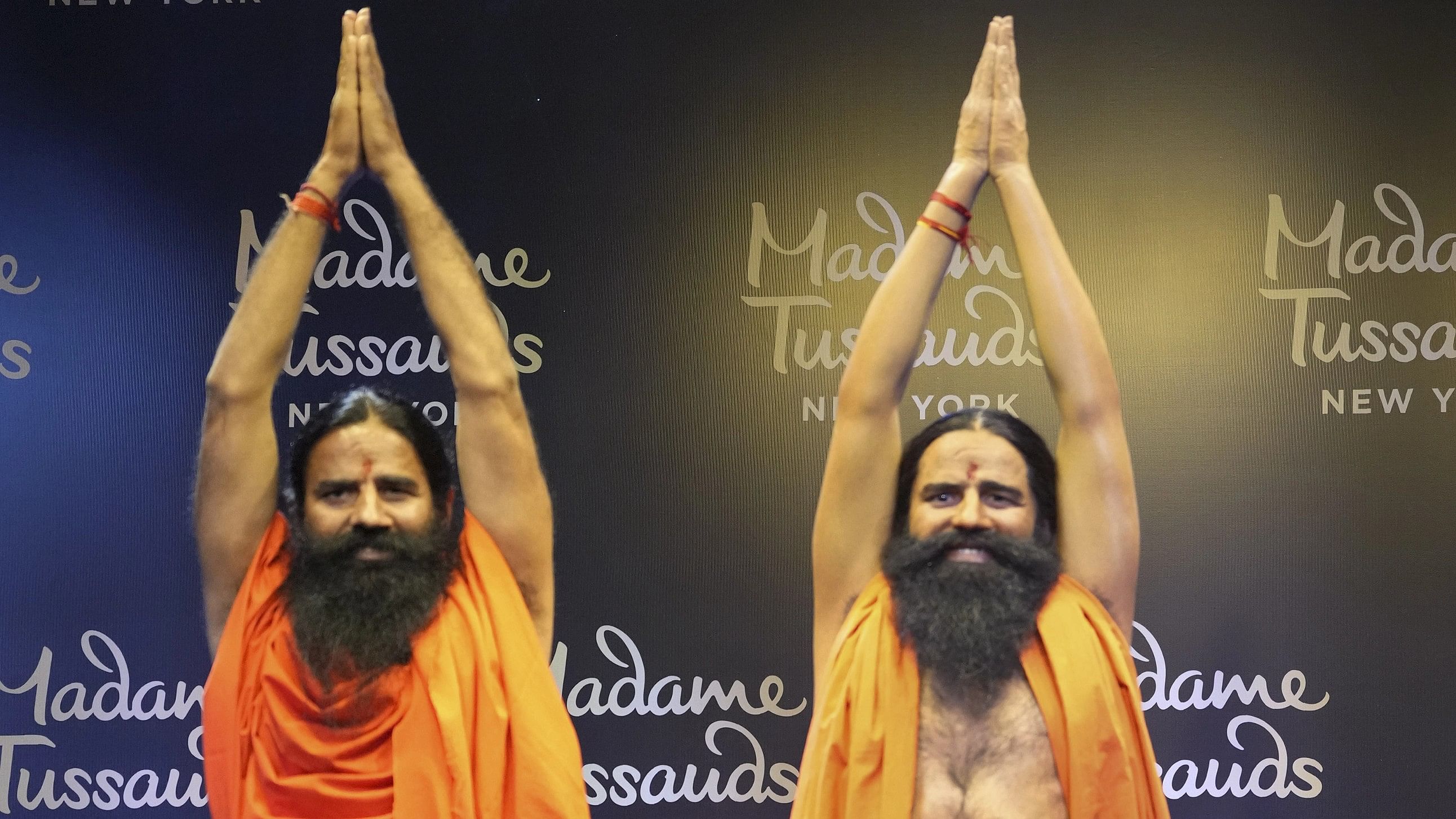<div class="paragraphs"><p>Yoga guru Ramdev poses for photos with his wax figure unveiled by Madame Tussauds New York, in New Delhi, Tuesday, Jan. 30, 2024. </p></div>
