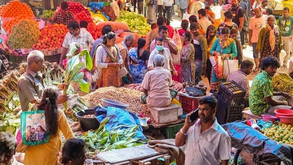 <div class="paragraphs"><p>People buy vegetables and groundnuts ahead of the Makar Sankranti festival, at a wholesale market in Bengaluru.</p></div>