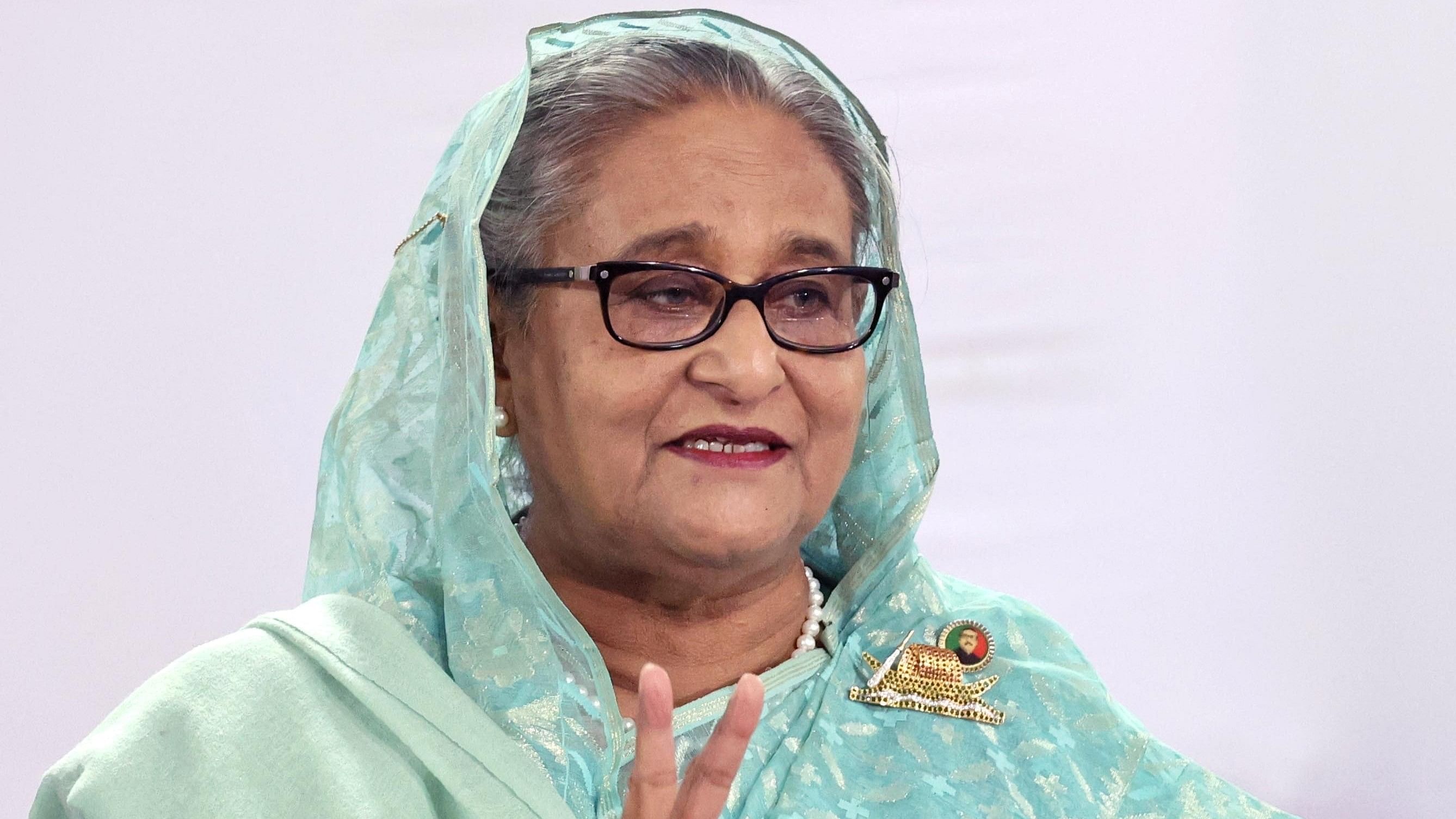 <div class="paragraphs"><p>Sheikh Hasina, Prime Minister of Bangladesh and Chairperson of Bangladesh Awami League, shows a victory sign while speaking to the press after casting her vote at the Dhaka City College center during the 12th general election in Dhaka, Bangladesh, January 7, 2024.  </p></div>