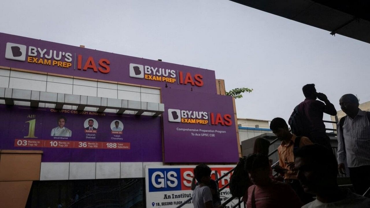 <div class="paragraphs"><p>People walk past an advertising hoarding of Byju's, an education technology company and one of India's biggest startup, outside one of its branch in New Delhi, India.</p></div>