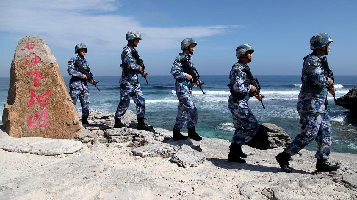 <div class="paragraphs"><p>Soldiers of China's People's Liberation Army Navy patrol at Woody Island, in the Paracel Archipelago.</p></div>