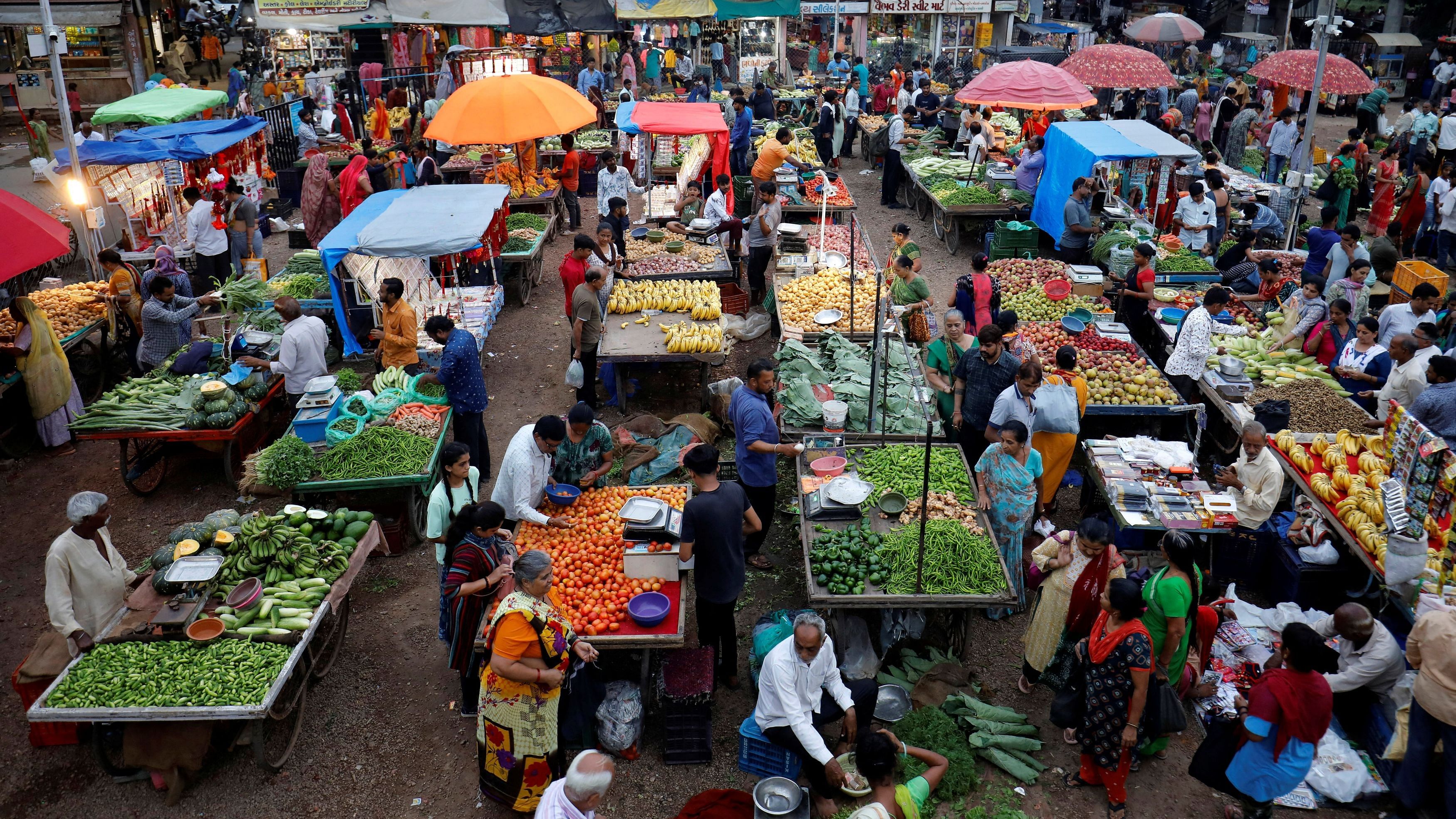 <div class="paragraphs"><p>Customers buy fruits and vegetables at an open air evening market in Ahmedabad, India.</p></div>